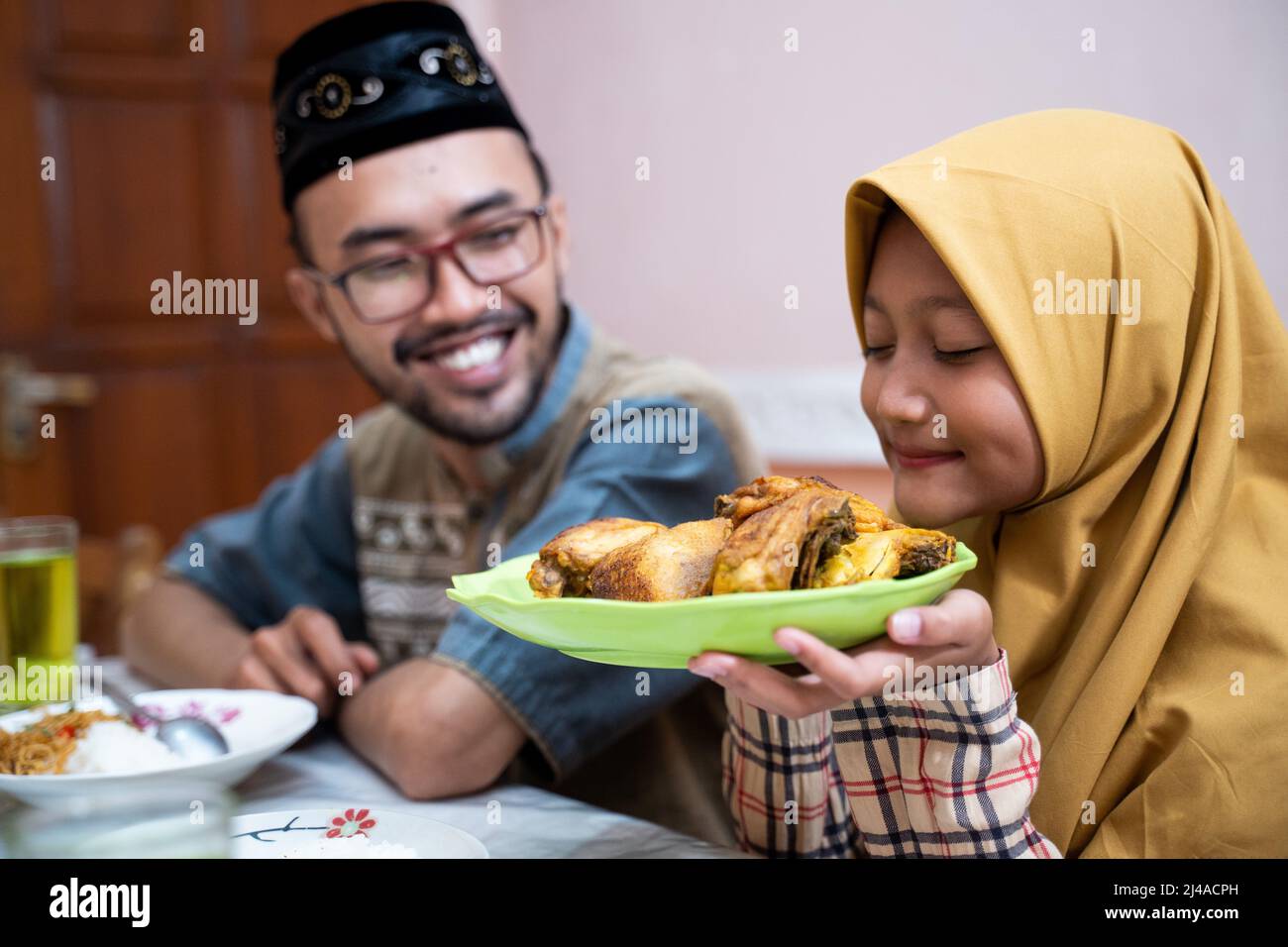 muslim father and daughter during iftar dinner on ramadan kareem Stock Photo