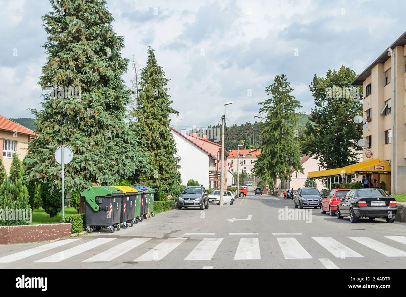 Main Road of a Small Provincial Town in Croatia. Beautiful Place, Clean, with Green Trees and Vehicles Parked Aside. Stock Photo