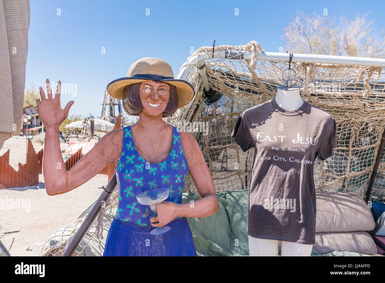 A waving cutout female figure in East Jesus, California. East Jesus is an off-the-grid art community in the Sonoran Desert of Southern California. The Stock Photo