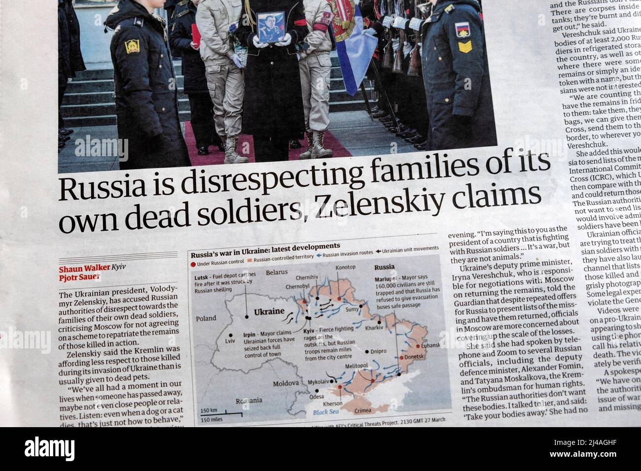 'Russia is disrespecting families of its own dead soldiers, Zelenskiy claims' Guardian newspaper headline inside page article 28 March 2022 London UK Stock Photo