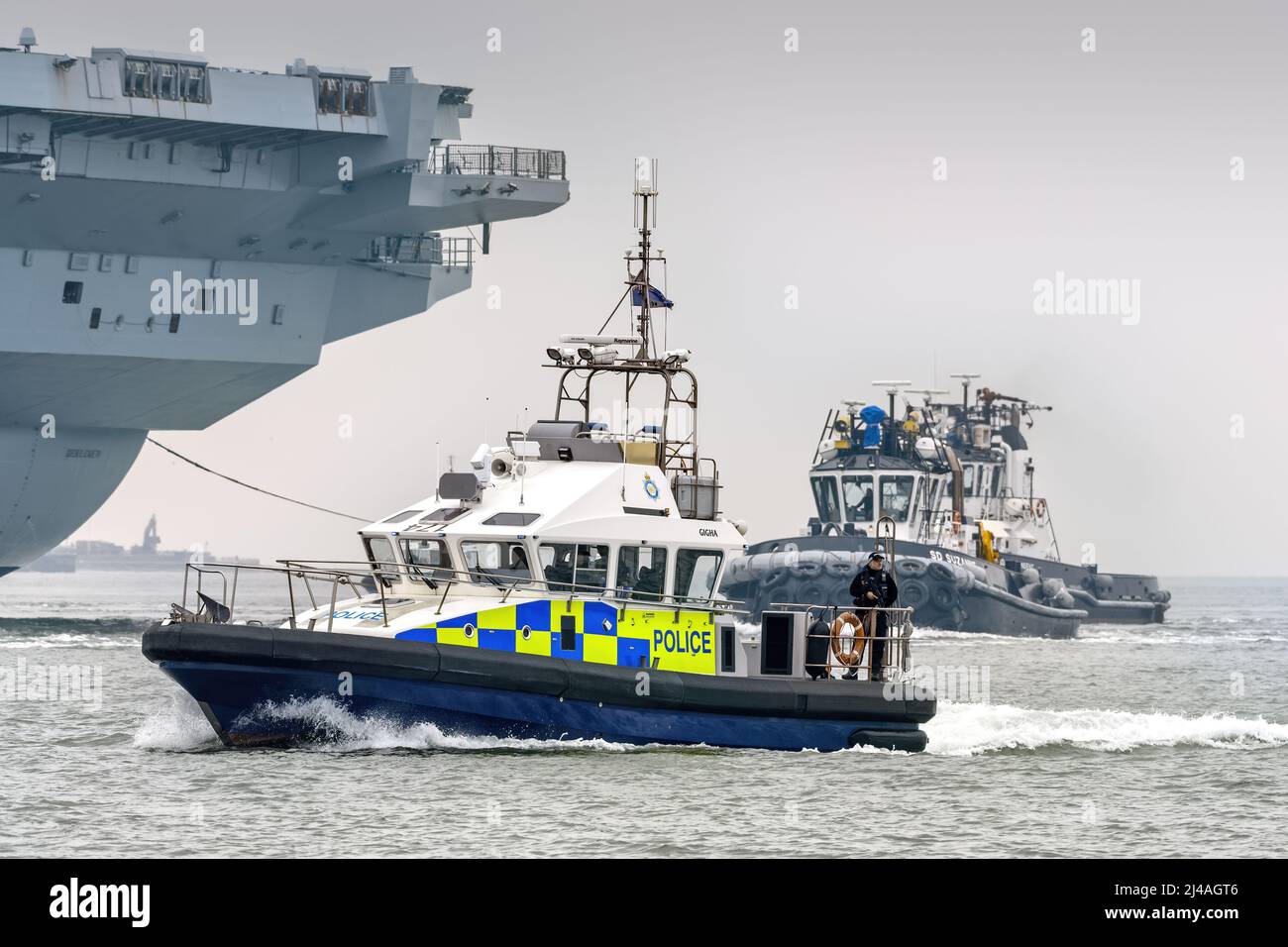 The Ministry of Defence Police patrol craft Gigha providing force protection for a Royal Navy warship at Portsmouth Harbour - March 2022. Stock Photo