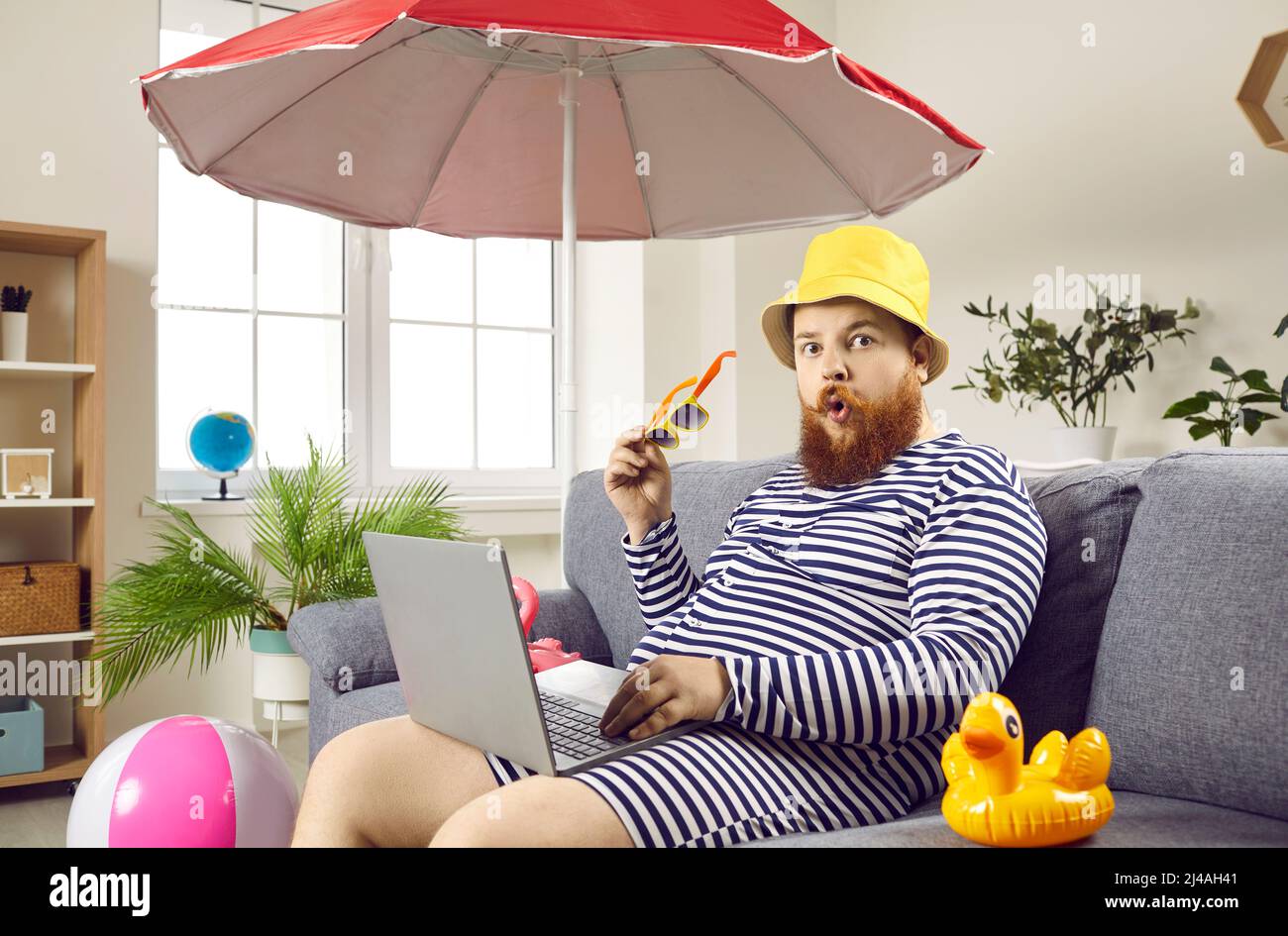 Funny chubby man is shocked that he is forced to spend summer vacation at home because of work. Stock Photo