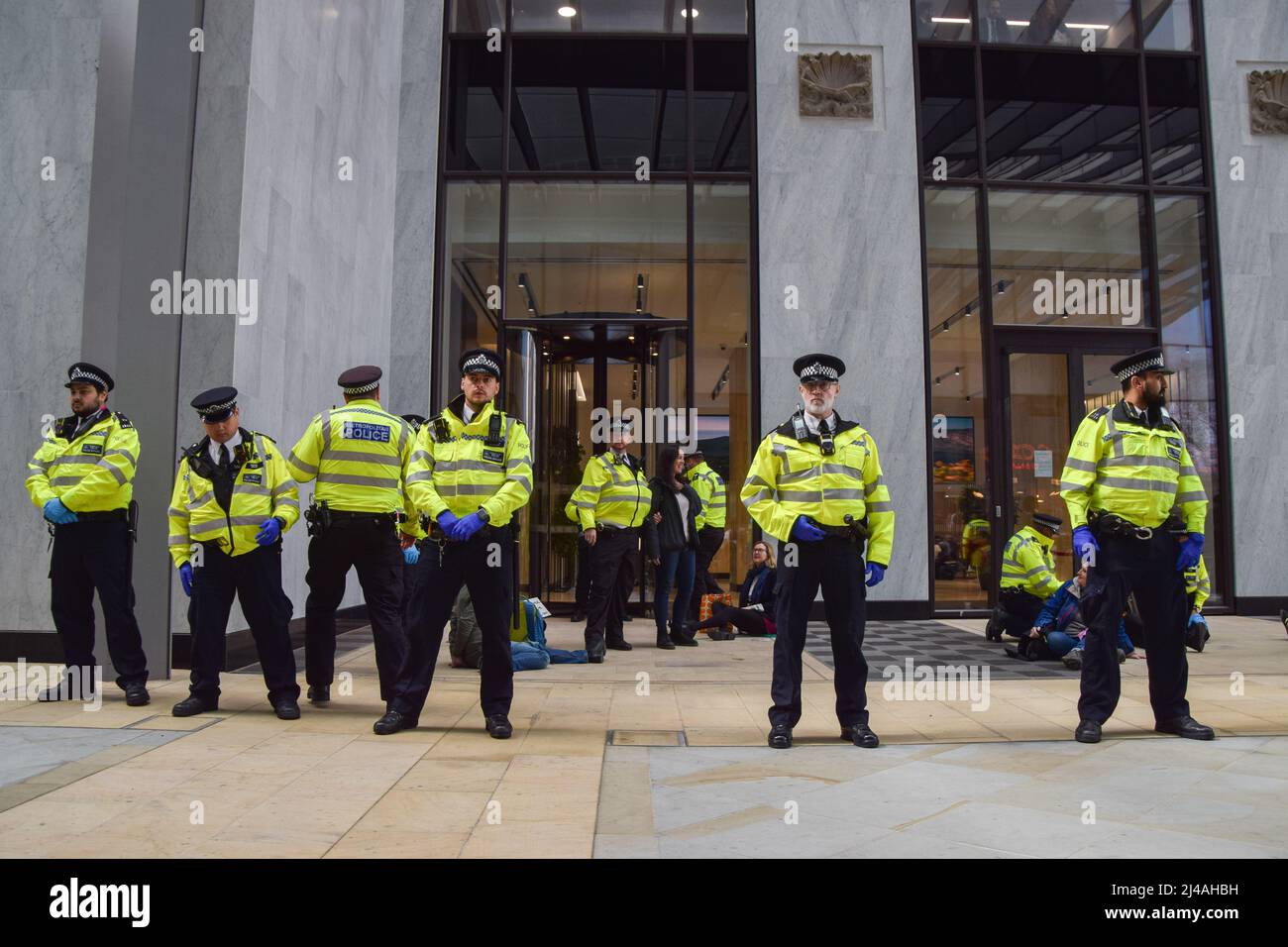 London, England, UK. 13th Apr, 2022. Police guard the entrance. Extinction Rebellion activists caused chaos at the London headquarters of oil giant Shell, with dozens of protesters gluing themselves to the floor outside the entrance and several inside the building. (Credit Image: © Vuk Valcic/ZUMA Press Wire) Stock Photo