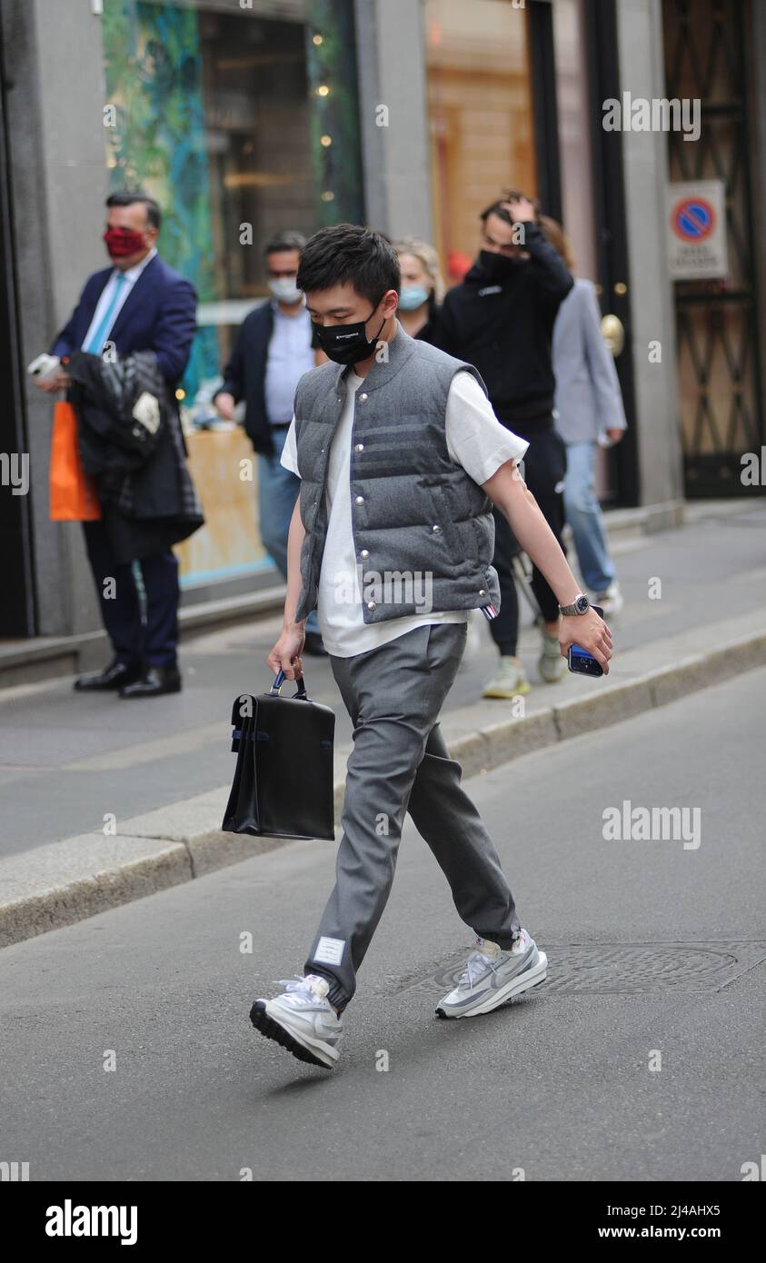 Milan, . 13th Apr, 2022. Milan, 13-04-2022 Steven Zhang, 30 years old, Chinese entrepreneur and President of INTER and SUNING INTERNATIONAL, after having parked his car that he usually uses in the city to go to work, walks towards the offices, trying to walk among the people in order not to be noticed and photographed. Credit: Independent Photo Agency/Alamy Live News Stock Photo