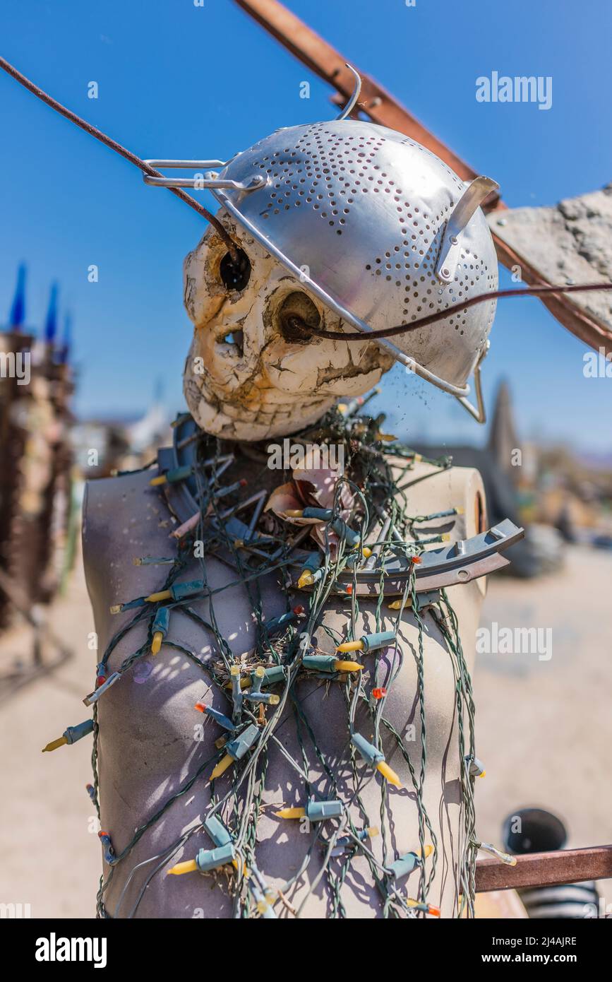A sculpture with a skelton face on a female mannequin body decorated with Christmas lights on its chest in the art community of East Jesus in the Sona Stock Photo