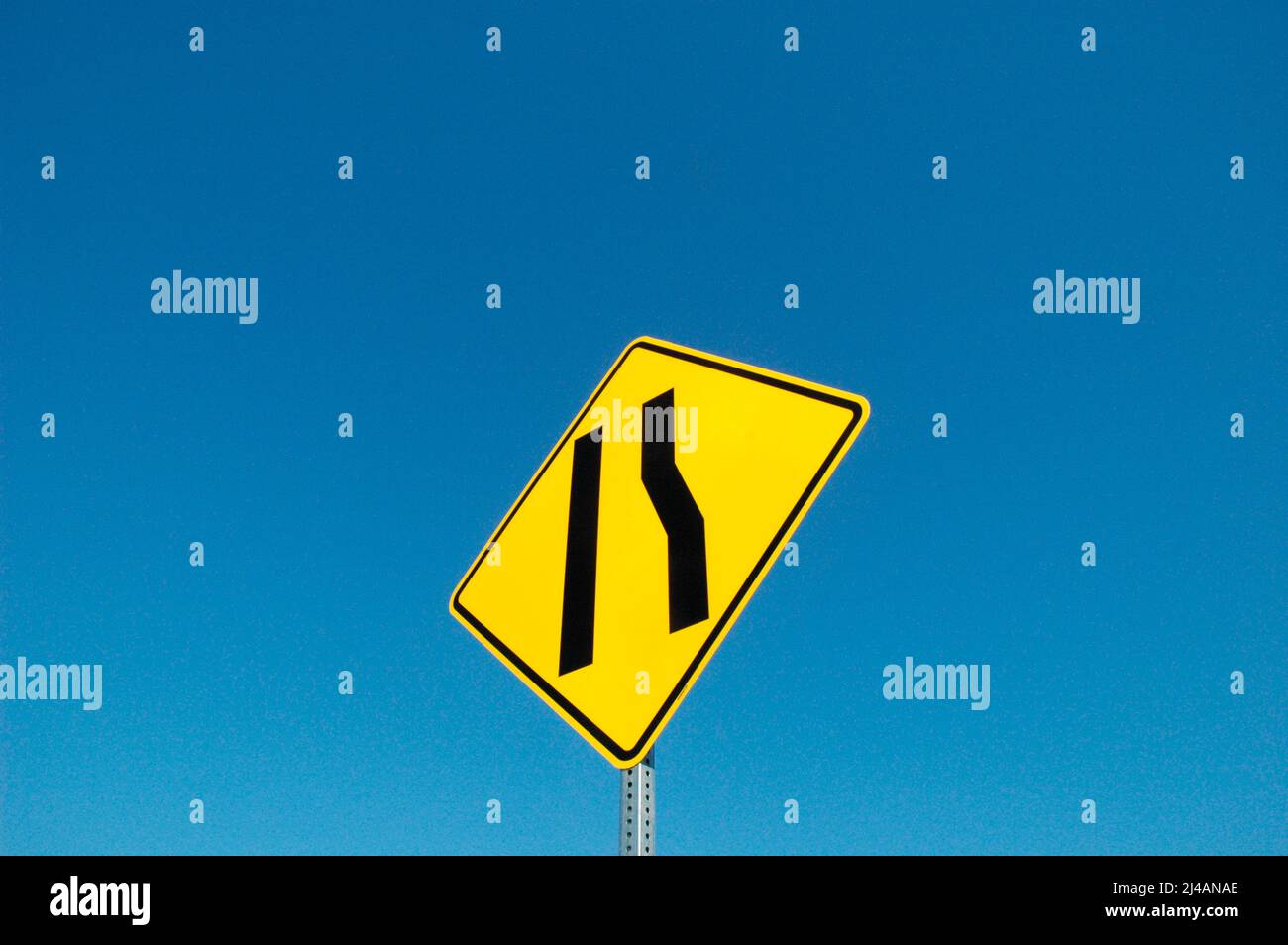 Freeway sign showing merge left as lane ends Stock Photo - Alamy