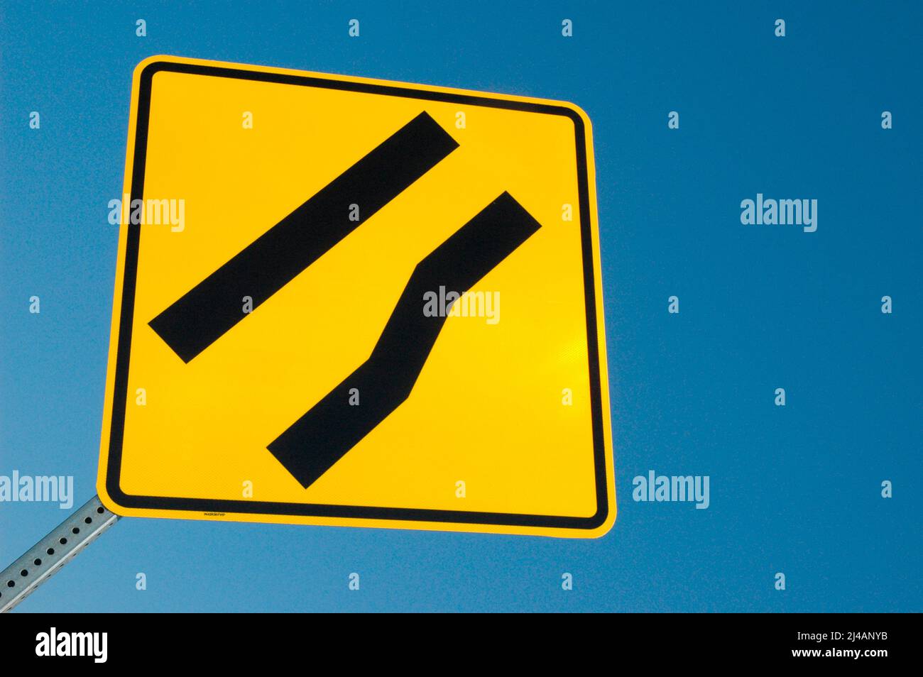 Freeway sign showing merge left as lane ends Stock Photo