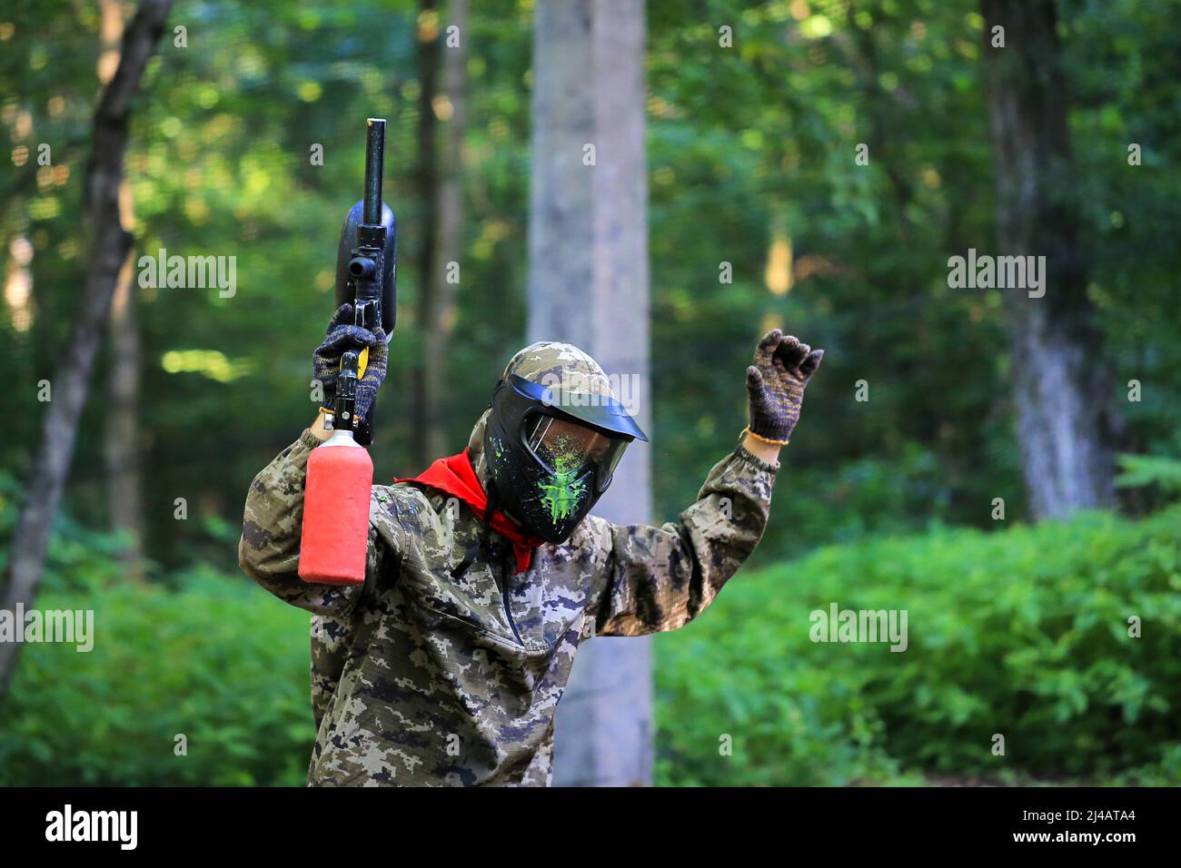 Paintball player is injured and surrenders with his hands up Stock Photo