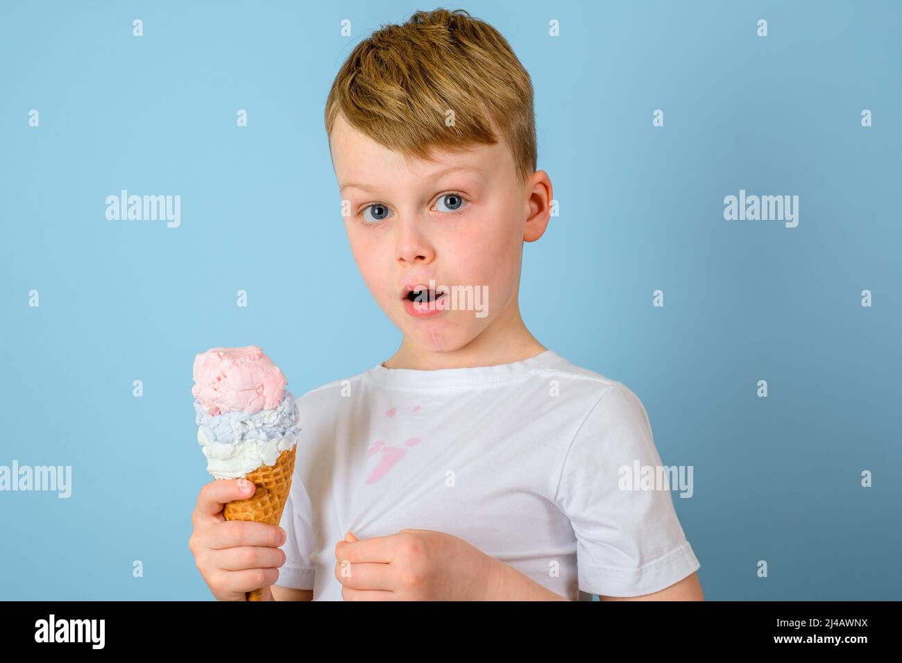 The boy is surprised dirty stains of ice cream on your clothes on a