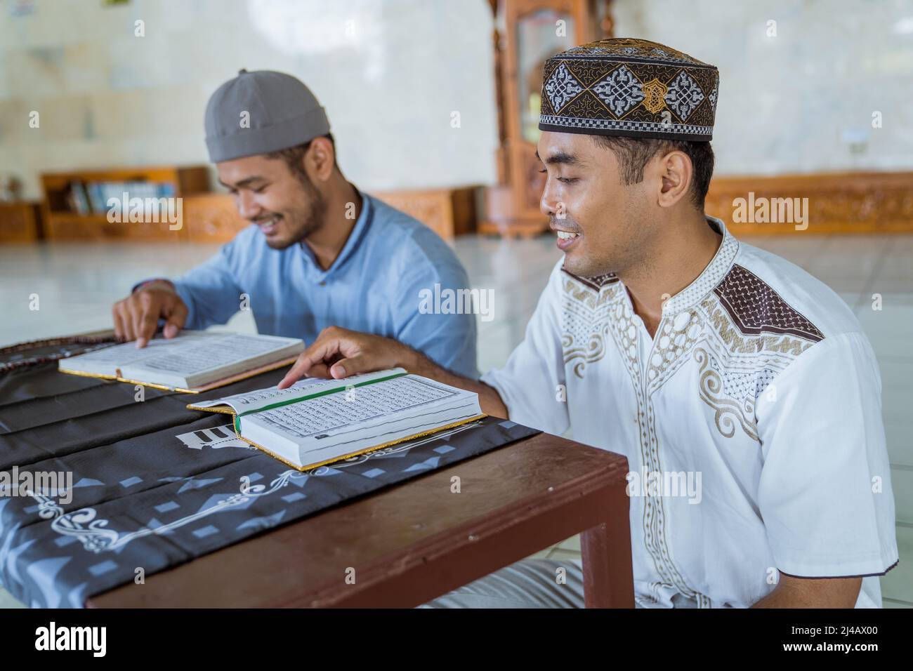 Man muslim learing to reading quran together during ramadan Stock Photo