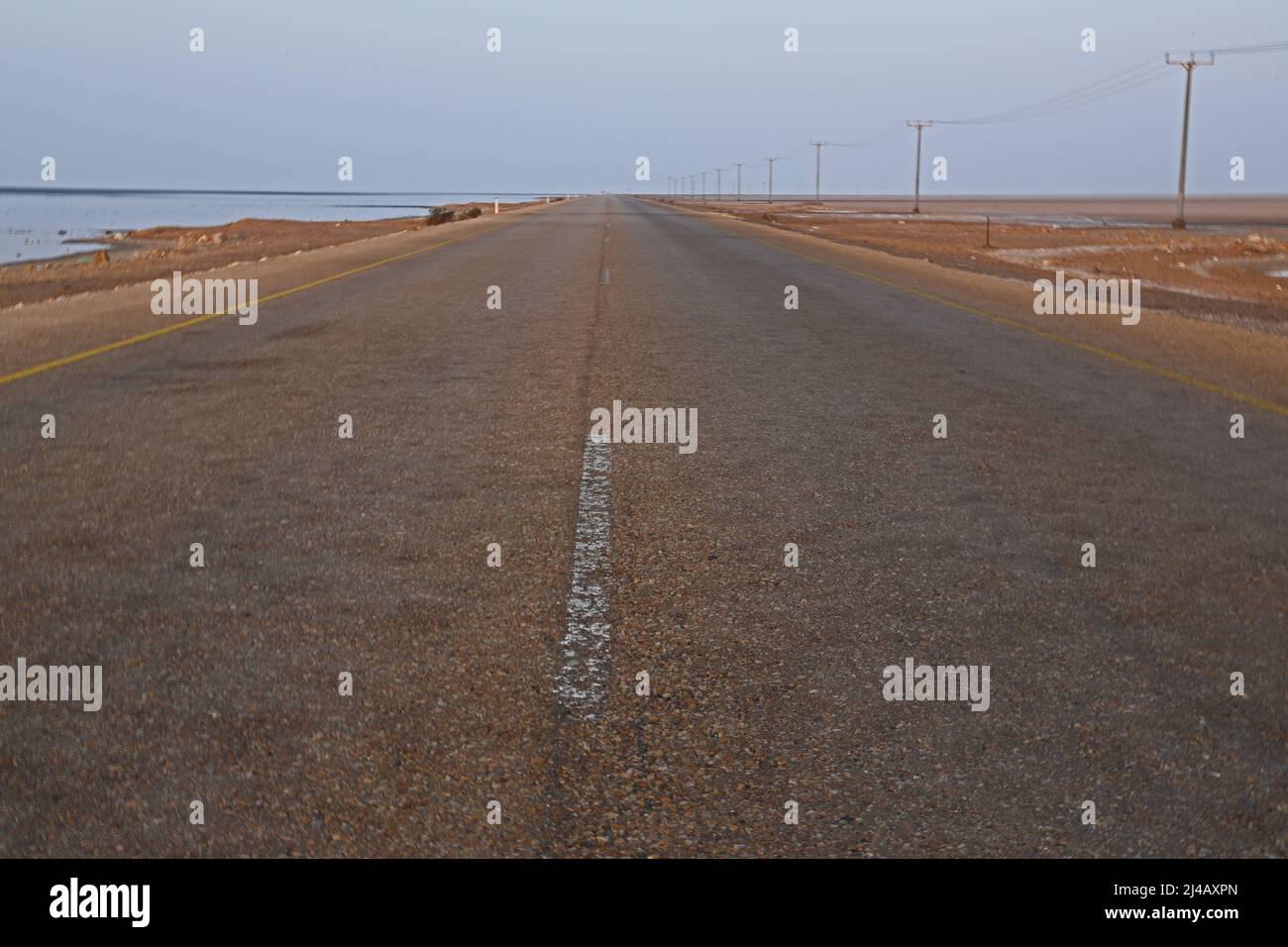 straight road over saltflats Oman                               December Stock Photo