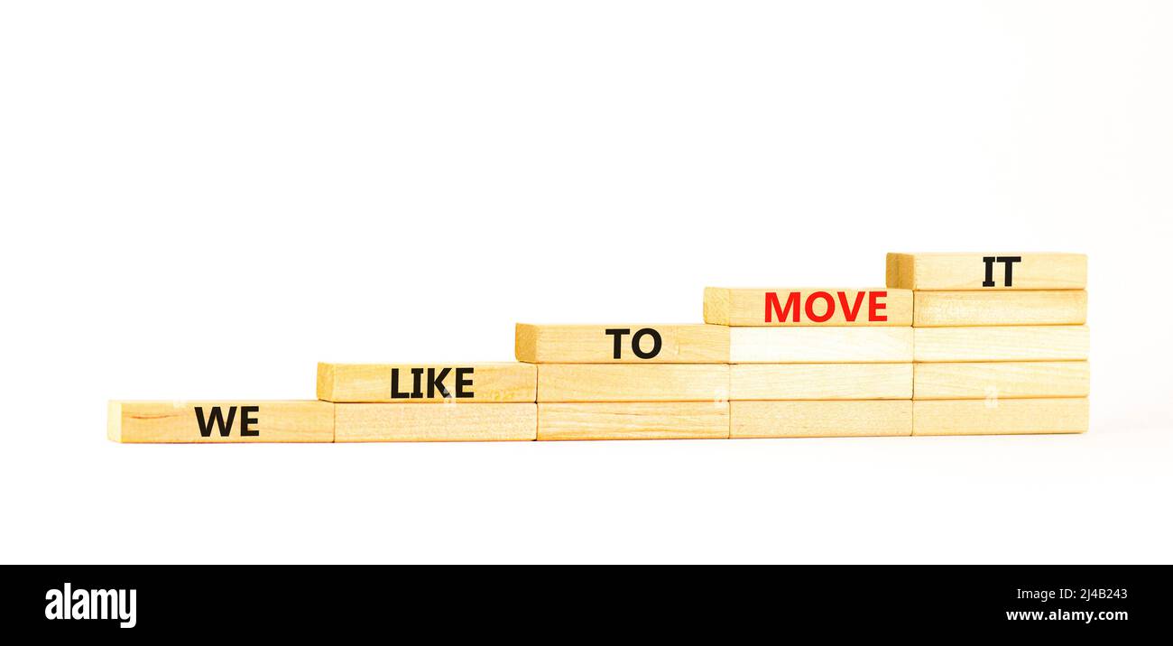 We like to move it symbol. Concept words We like to move it on wooden blocks. Beautiful white table white background. Business motivational We like to Stock Photo