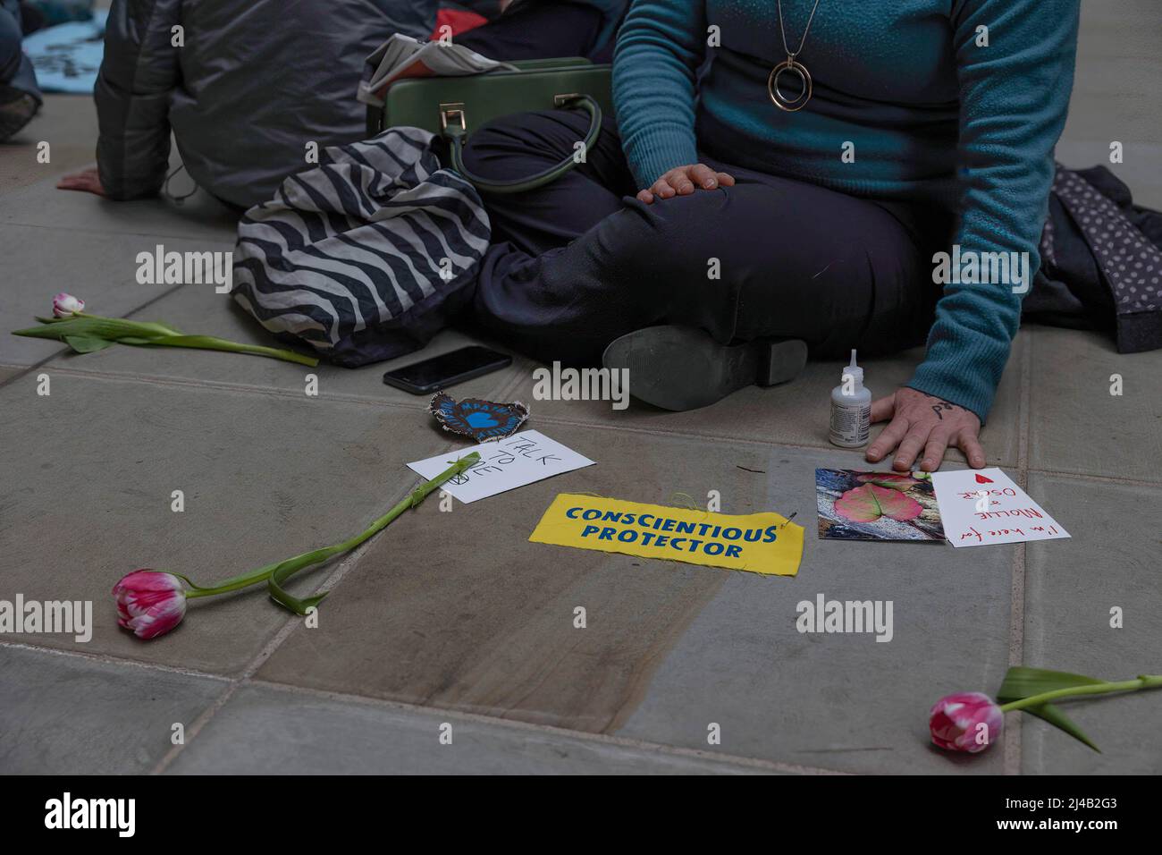 London, UK. 13th Apr, 2022. Placards with flowers and super glue seen