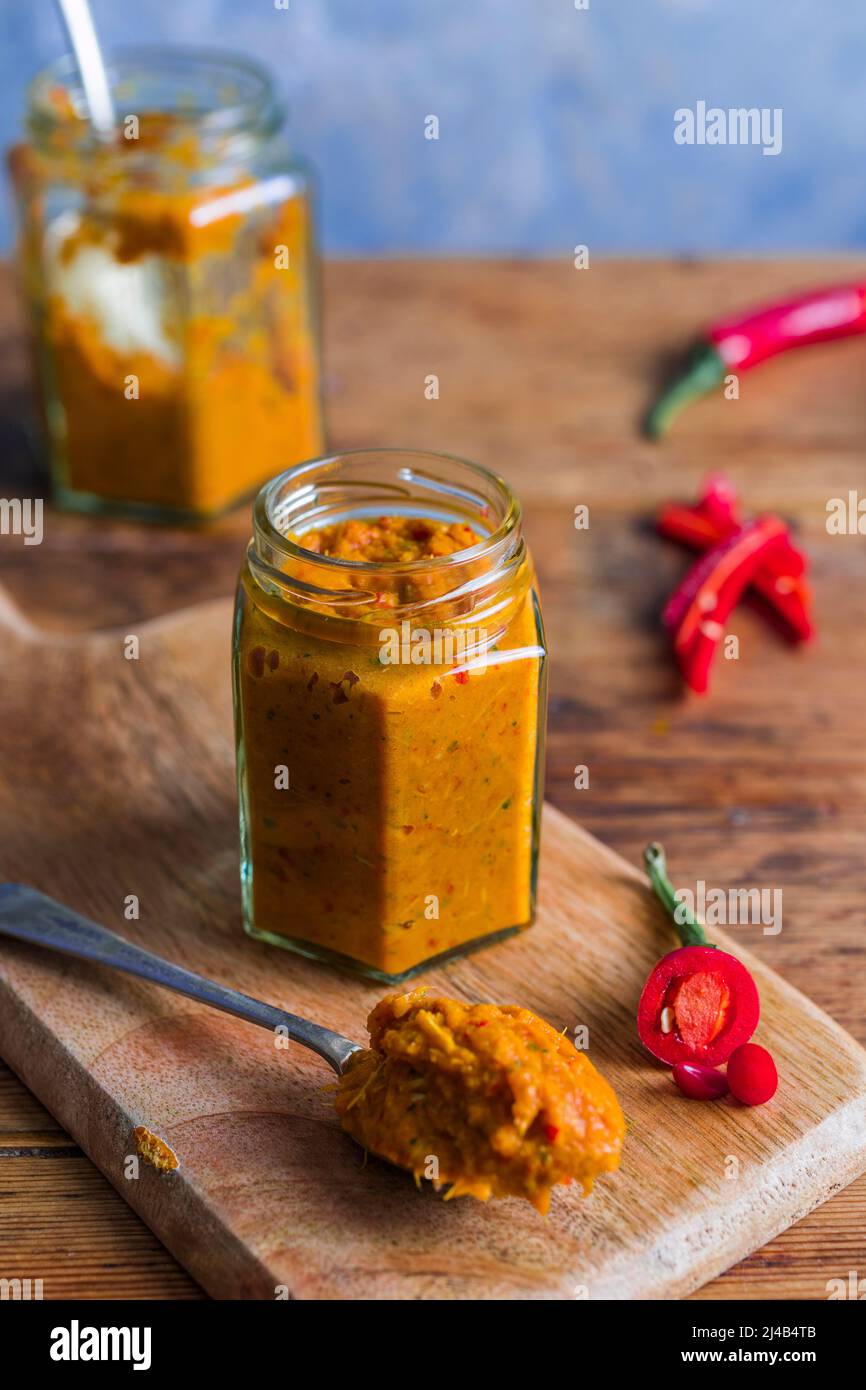 Jar of homemade Thai red curry paste Stock Photo