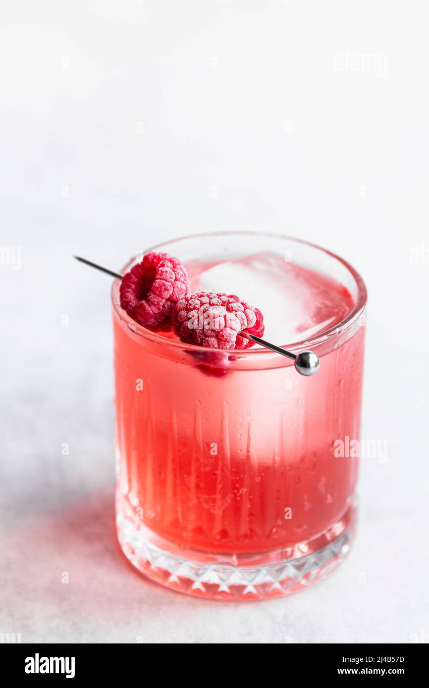 Raspberry cocktail with frozen raspberries. Stock Photo