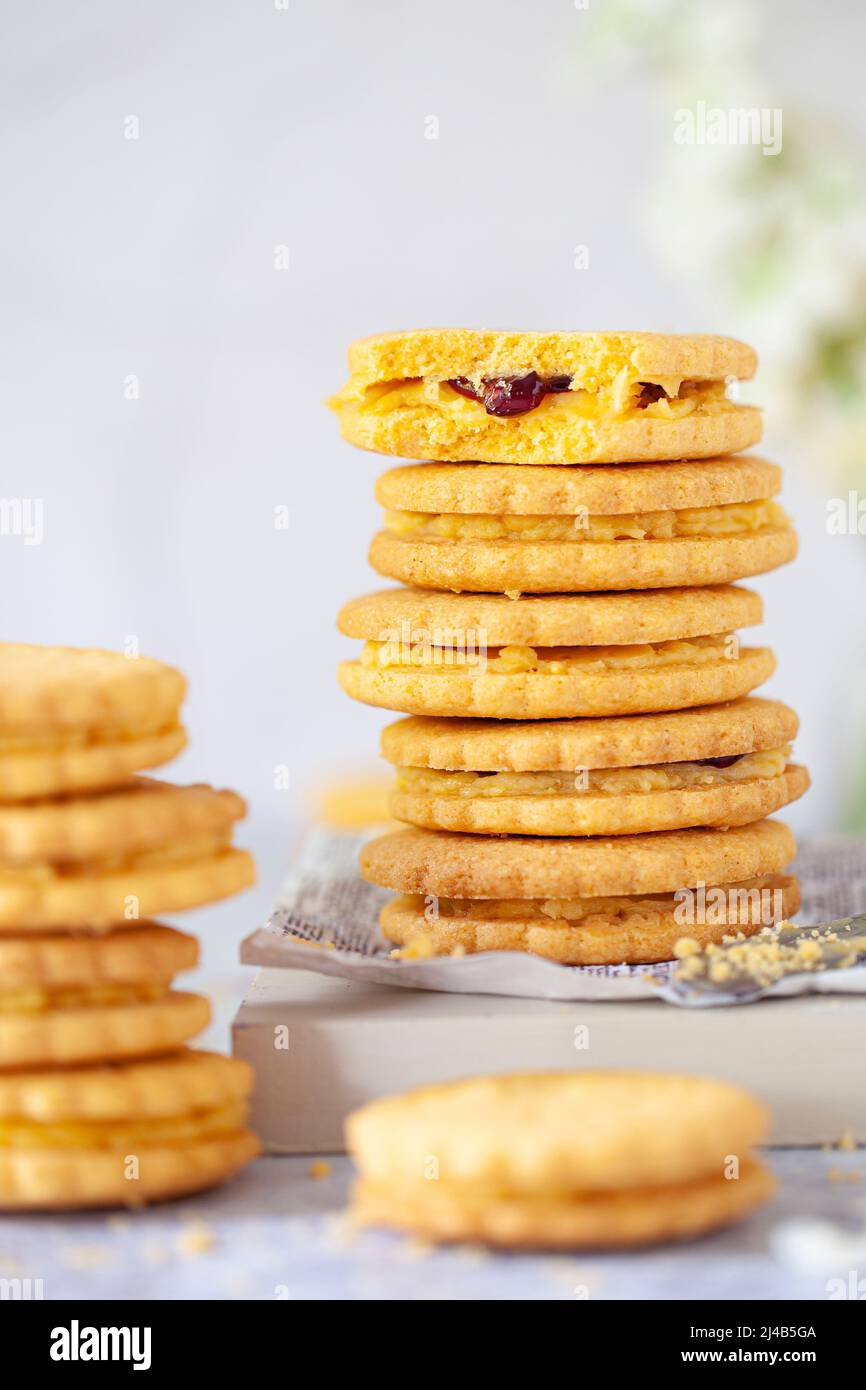 Stacks of custard cream style sandwich biscuits filled with buttercream