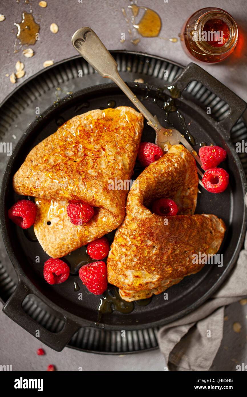 North Staffordshire oatcake pancake served with raspberries and golden syrup. Stock Photo
