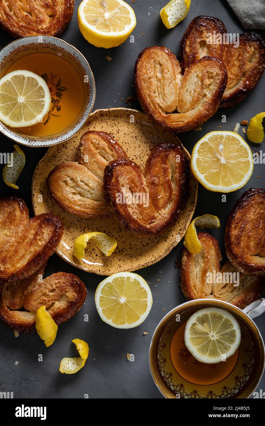 Lemon Palmiers, made from puff pastry on a dark background Stock Photo