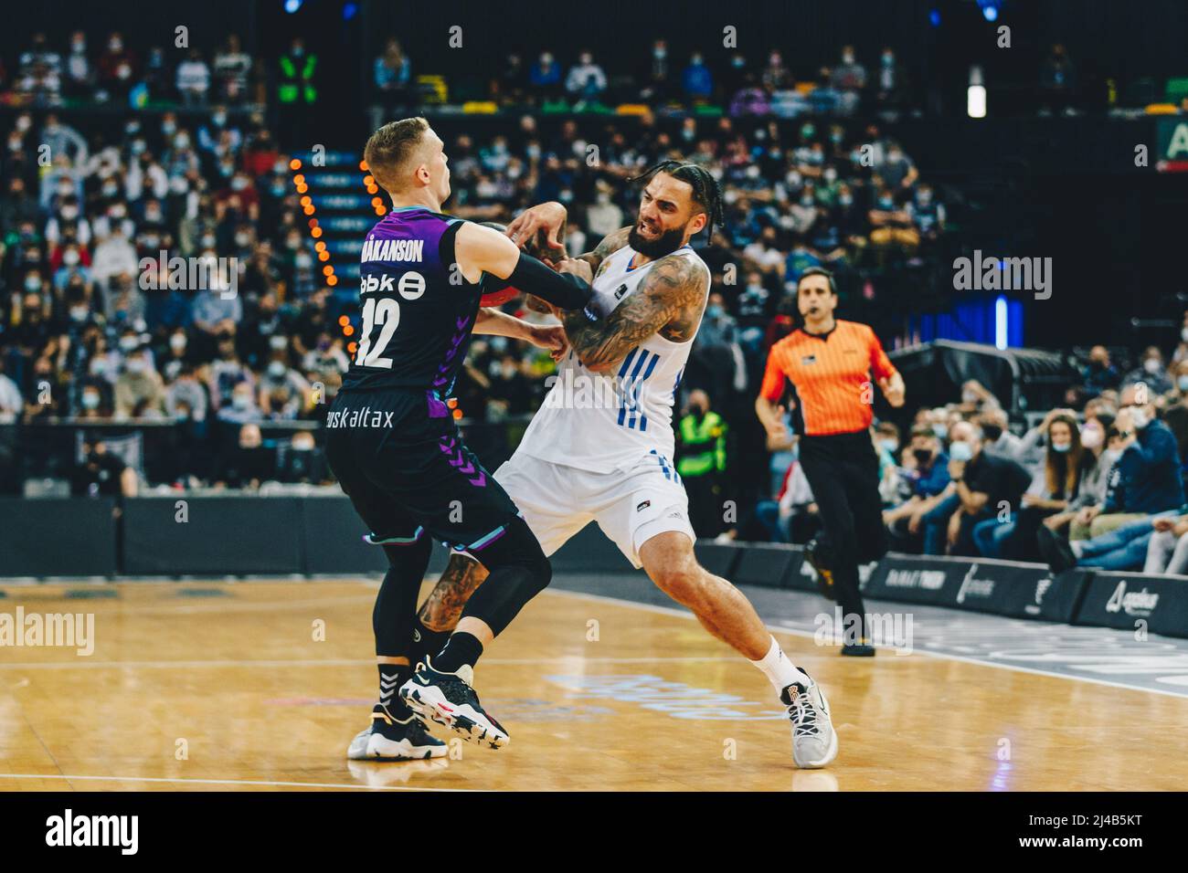 Bilbao, Basque Country, SPAIN. 13th Apr, 2022. LUDDE HAKANSON (12) of Bilbao  Basket and JEFF TAYLOR (44) of Real Madrid fighting for the ball during the  Liga ACB game between Surne Bilbao