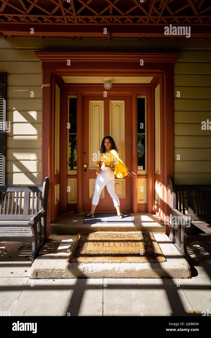 Portrait of a Colorful Young Black Woman in Victorian Doorway Stock Photo