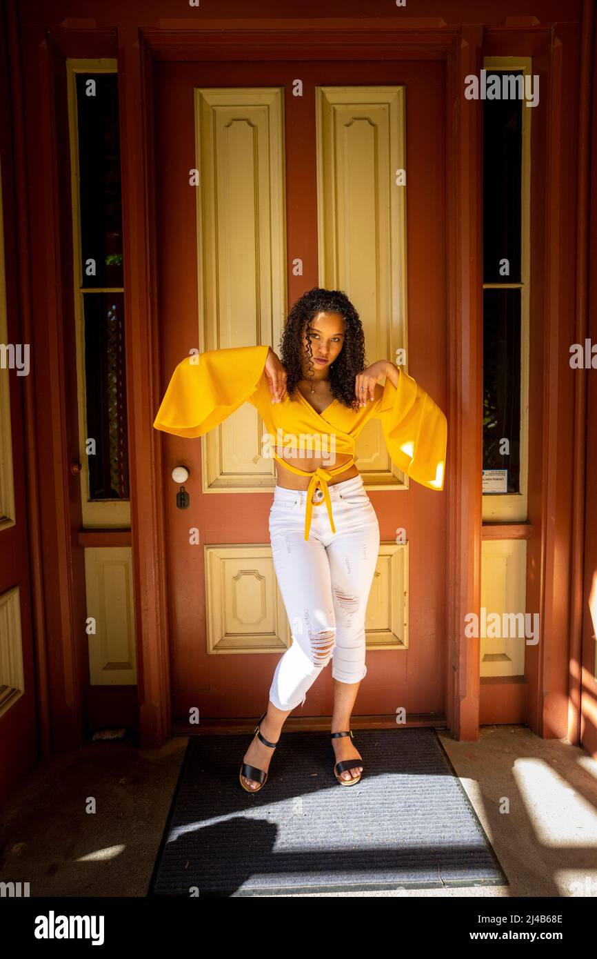 Portrait of a Colorful Young Black Woman in Victorian Doorway Stock Photo