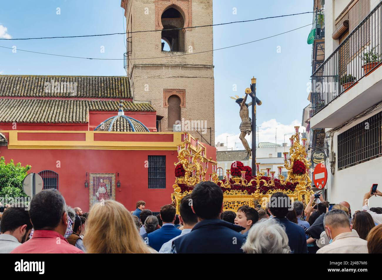 Seville, Spain; April 13, 2022: Procession during the Holy Week in the streets of Seville.  Brotherhood of 'El Buen Fin'.  San Lorenzo Church in the b Stock Photo