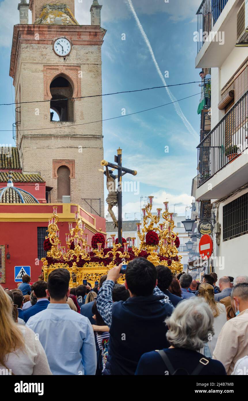 Seville, Spain; April 13, 2022: Procession during the Holy Week in the streets of Seville.  Brotherhood of 'El Buen Fin'.  San Lorenzo Church in the b Stock Photo