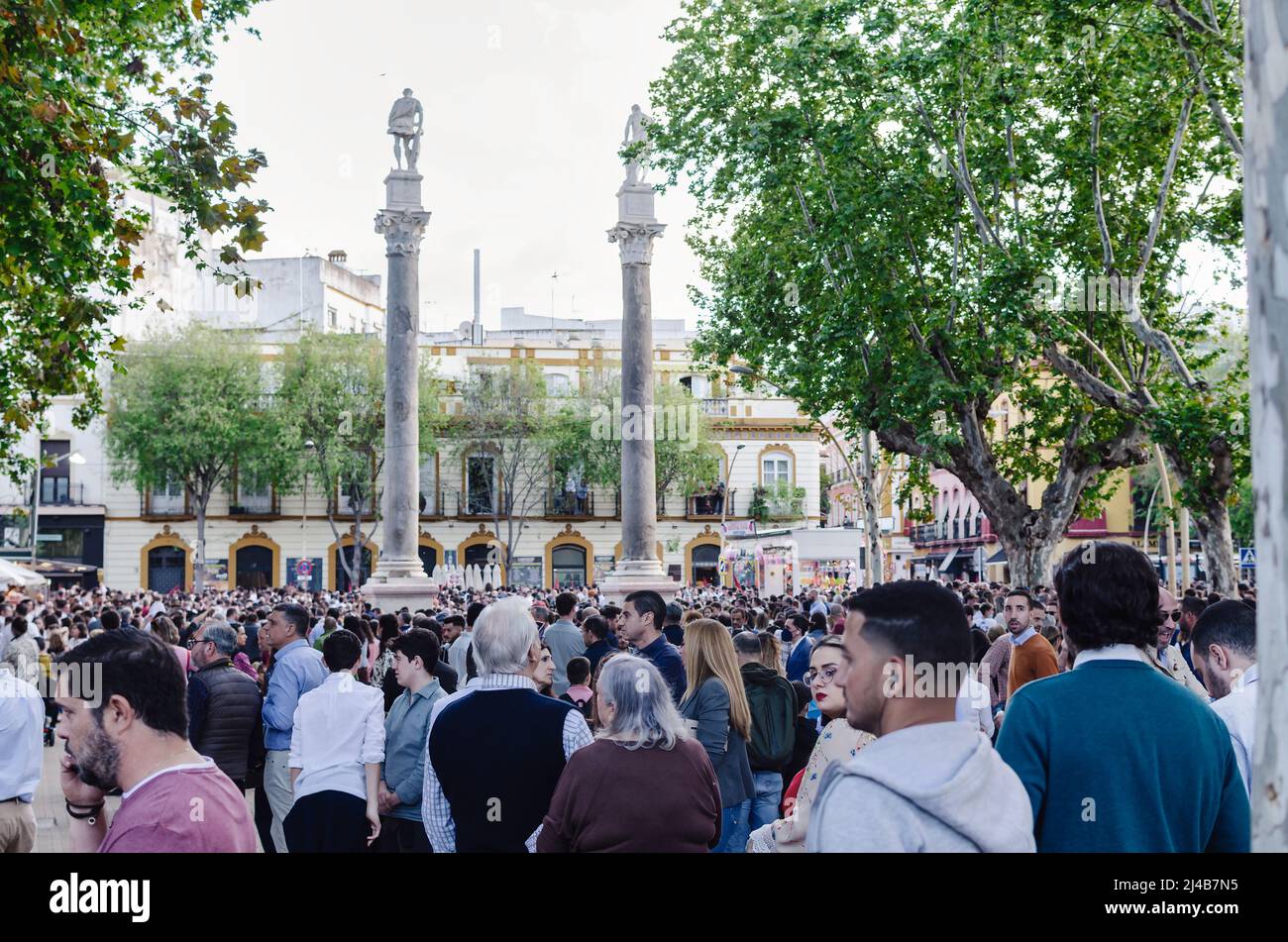 Seville, Spain; April 13, 2022: Crowd of people waiting for a procession during the Holy Week. Alameda Square. Stock Photo