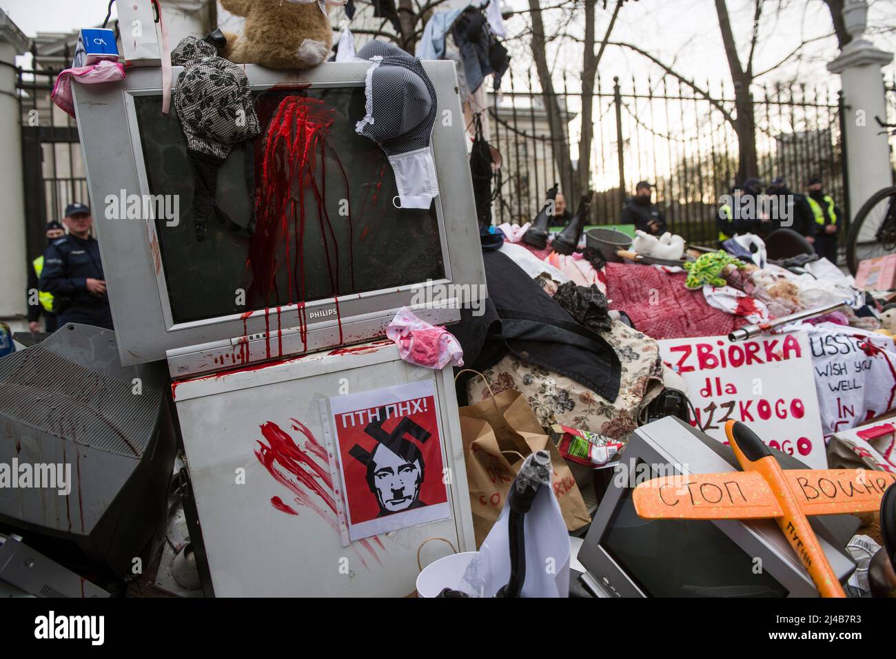 A placard depicting Russian President Vladimir Putin seen on an old fridge during an anti-Russian protest outside the Russian embassy. An anti-Russian protest took place in Warsaw in front of the Russian embassy.Warsaw citizens and Ukrainians brought absolutely every junk that could be found in the basement to the embassy. All the rubbish was covered with red paint, which symbolizes the blood of murdered Ukrainian civilians. The action was aimed at publicizing the disgraceful behavior of the soldiers of the Russian Federation who rob Ukrainian towns and villages, torture civilians, commit geno Stock Photo