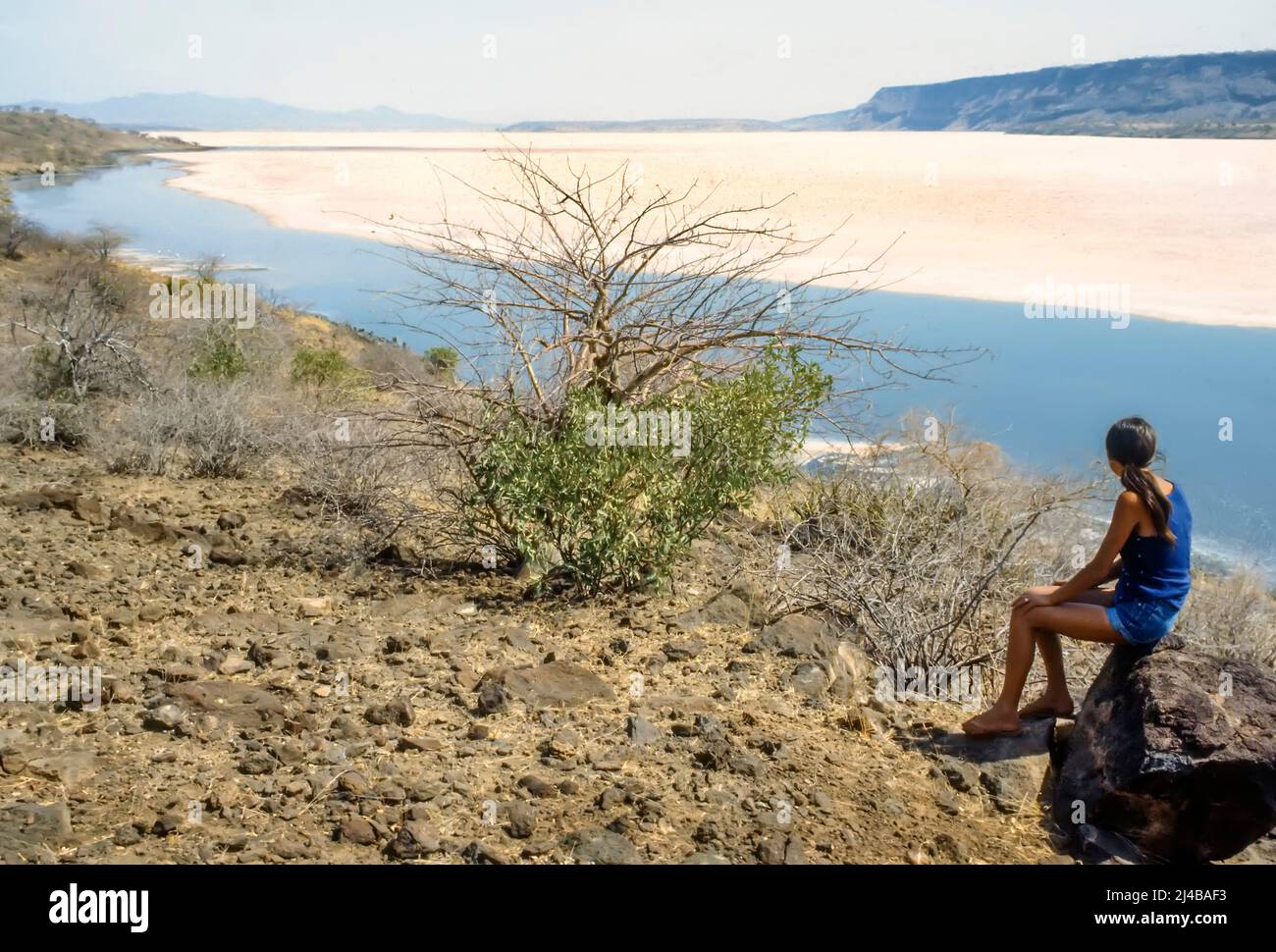 Woman looking at Lake Magadi salt lake Kenya Stock Photo