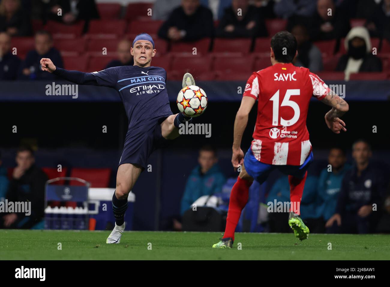 Madrid, Spain, 13th April 2022. Phil Foden of Manchester City stretches for the ball as Stefan Savic of Atletico Madrid closes in during the UEFA Champions League match at Wanda Metropolitano Stadium, Madrid. Picture credit should read: Jonathan Moscrop / Sportimage Credit: Sportimage/Alamy Live News Stock Photo