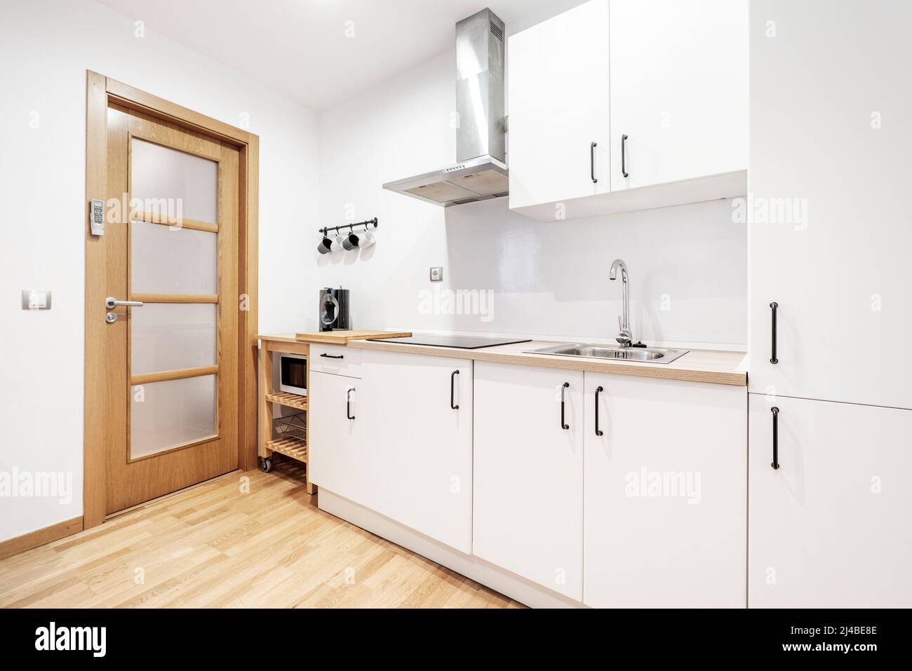 Kitchen with white and light wood countertops with matching wood stainless