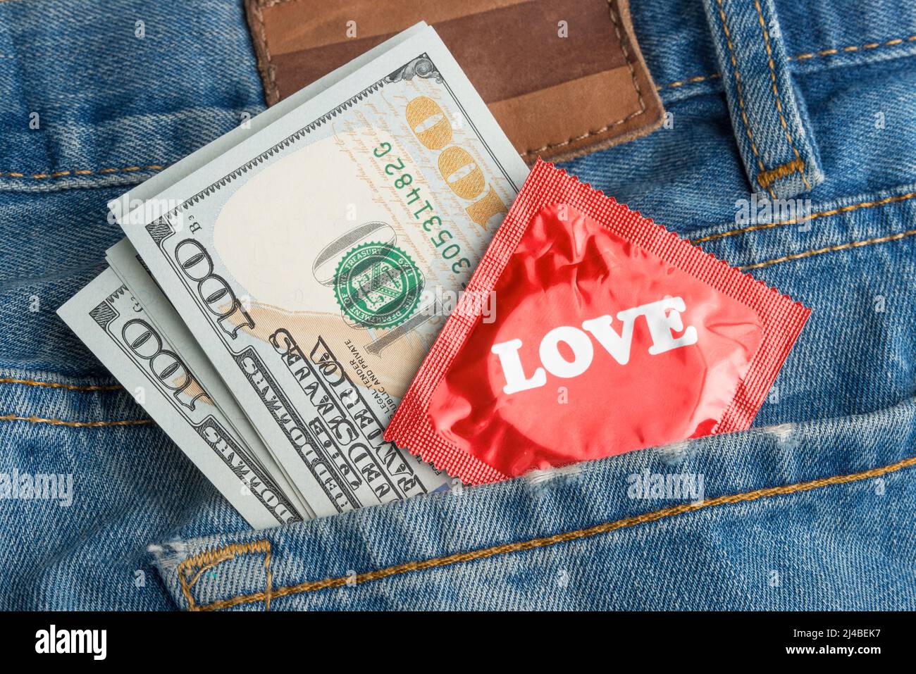 Condom and money in your jeans pocket Stock Photo Alamy