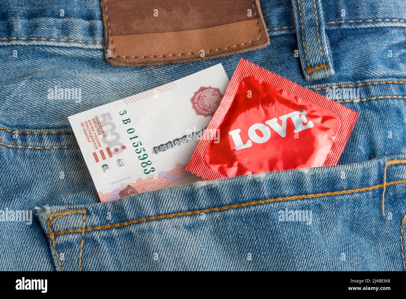 Condom and money in your jeans pocket Stock Photo Alamy