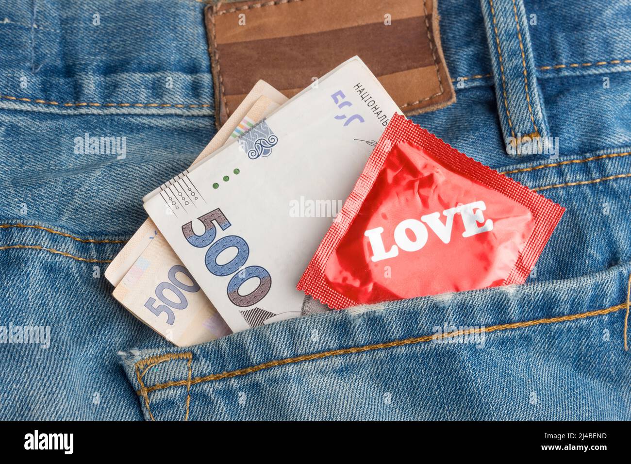 Condom and money in your jeans pocket Stock Photo Alamy