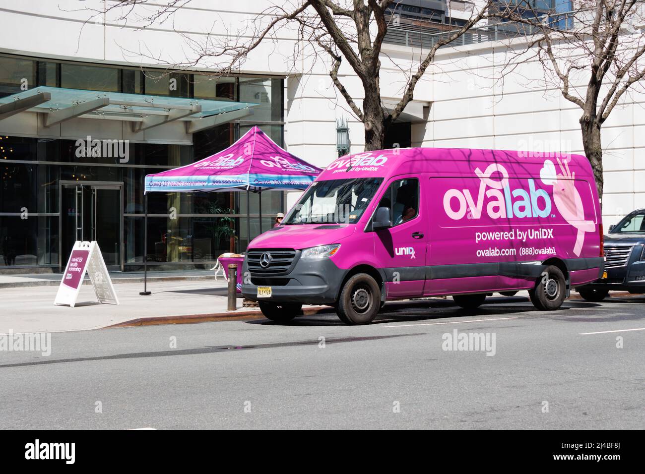 a van and sidewalk tent of Ovalab, a mobile medical testing clinic that specifically focuses its testing on women's health care issues in New York and Stock Photo