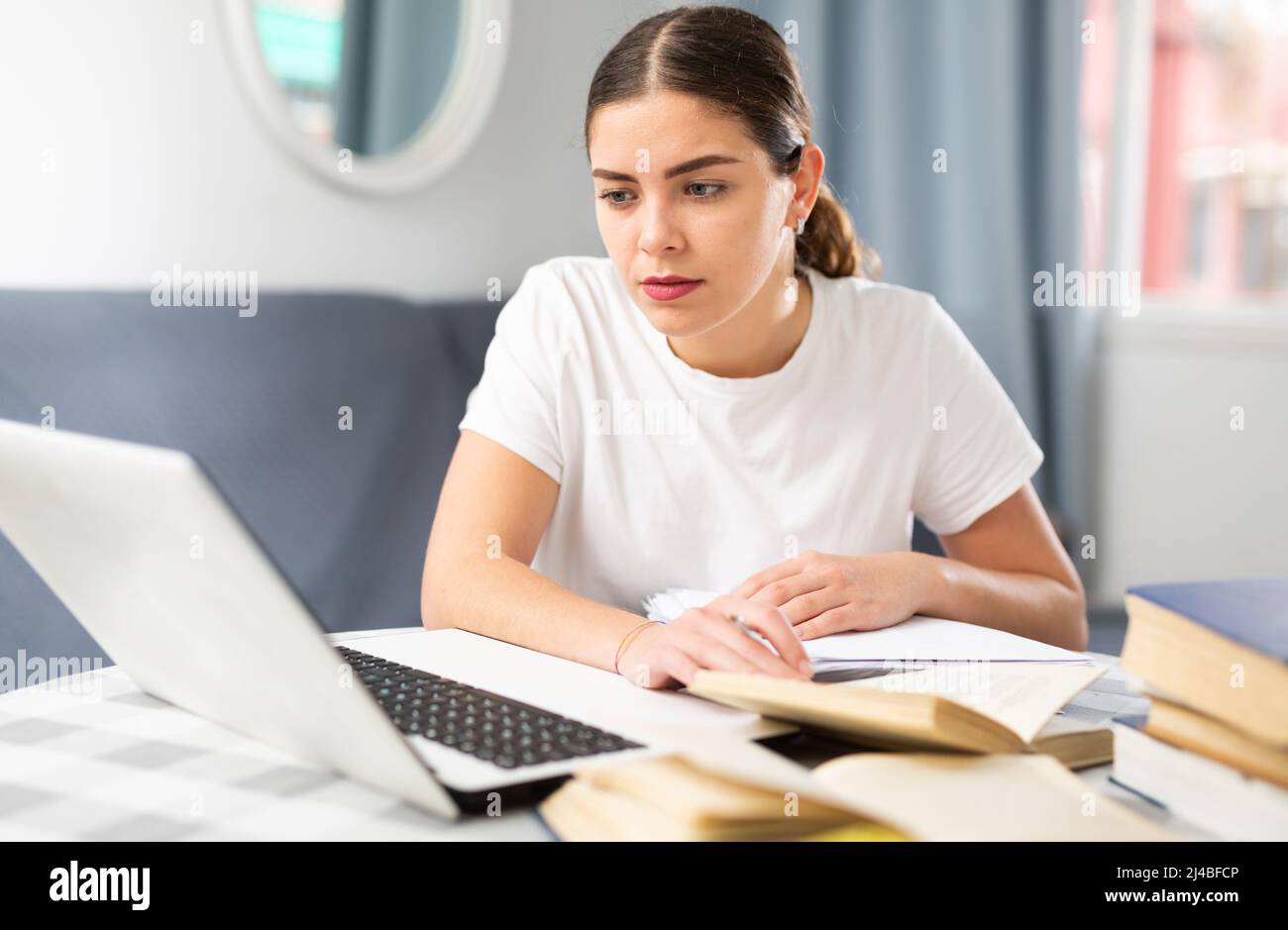 Distance learning concept. Woman using laptop studying Stock Photo - Alamy