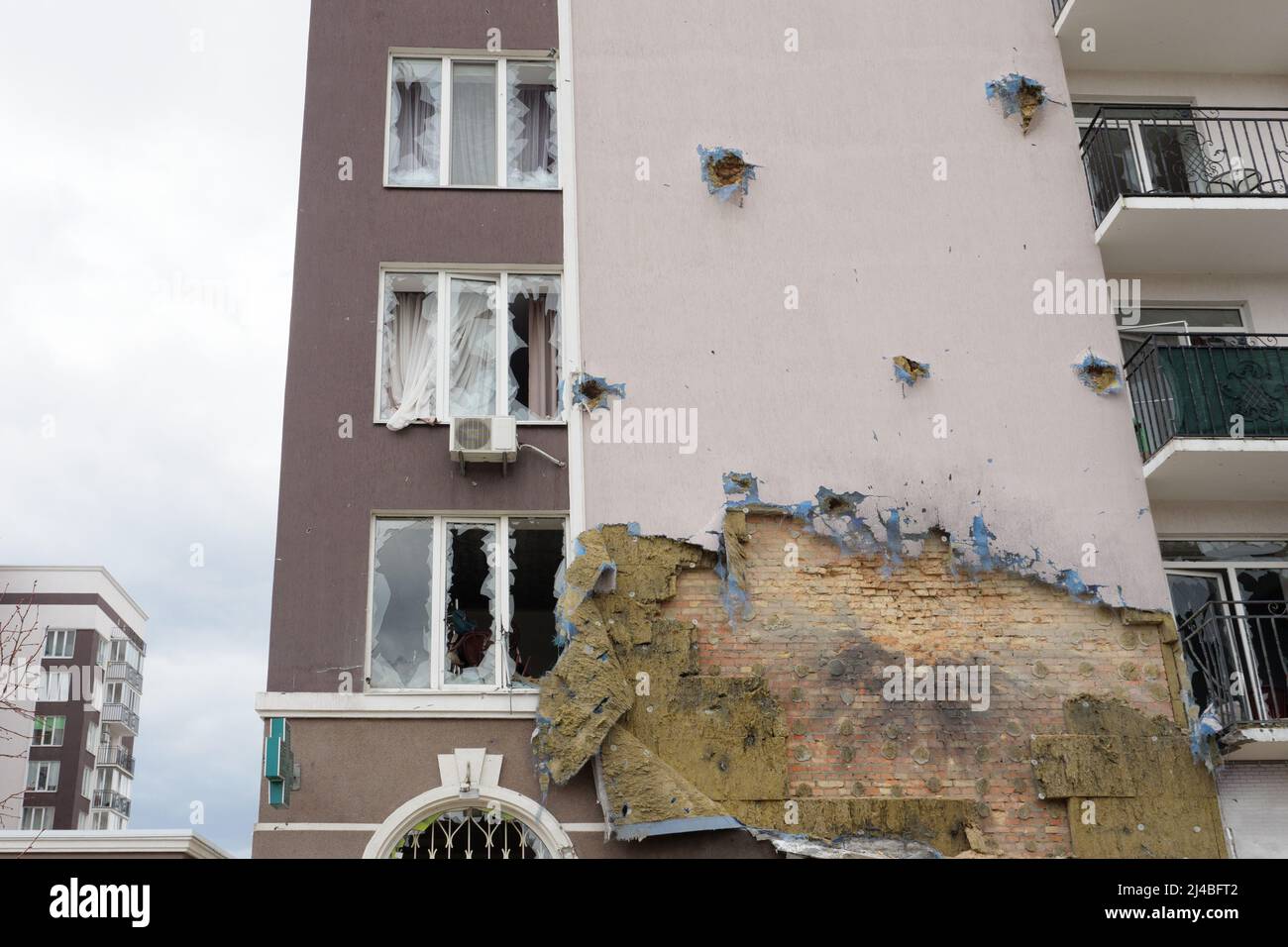2022 Russian invasion Ukraine war Bucha destroyed building destruction wall hole shot Irpin aftermath shell of civilian hitting city Bucha damage Stock Photo