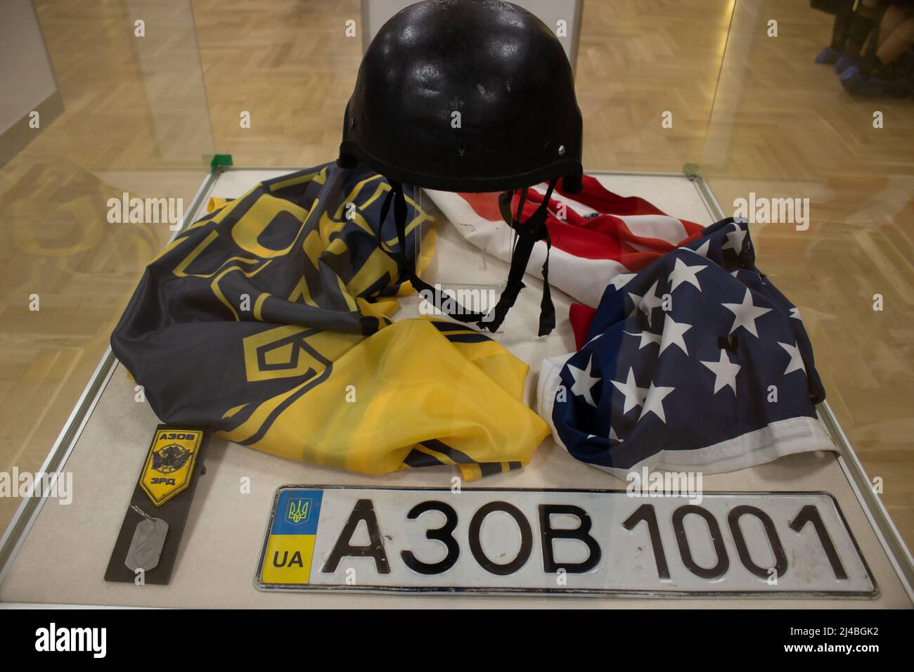 Trophies captured by the Russian military in Ukraine in 2022 are on display at the State Central Museum of Contemporary History of Russia in Moscow. The sign reads: “Protective helmet of a soldier of the Armed Forces of Ukraine with an emblem indicating affiliation to the SS. Ukraine, 2022. The flag of the Azov special operations detachment that adheres to far-right and neo-Nazi ideology and uses weapons provided by NATO. Ukraine, 2022. U.S. flag with traces of shelling. Ukraine, 2022. A patch and badge of a soldier of the Azov special operations detachment that adheres to far-right and neo-Na Stock Photo