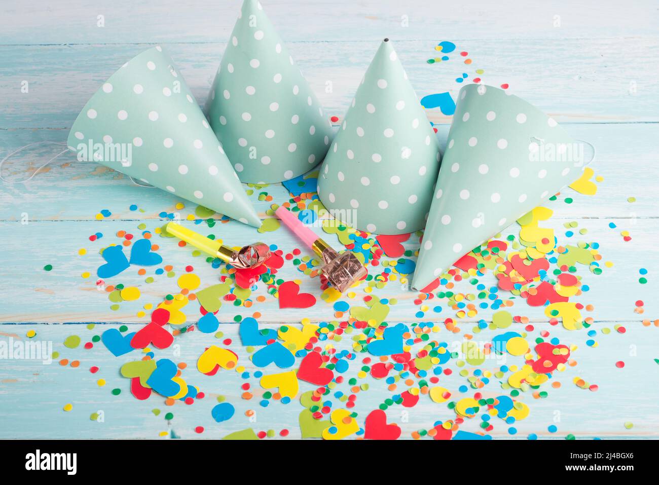 Birthday caps, blowers and confetti on background Stock Photo - Alamy