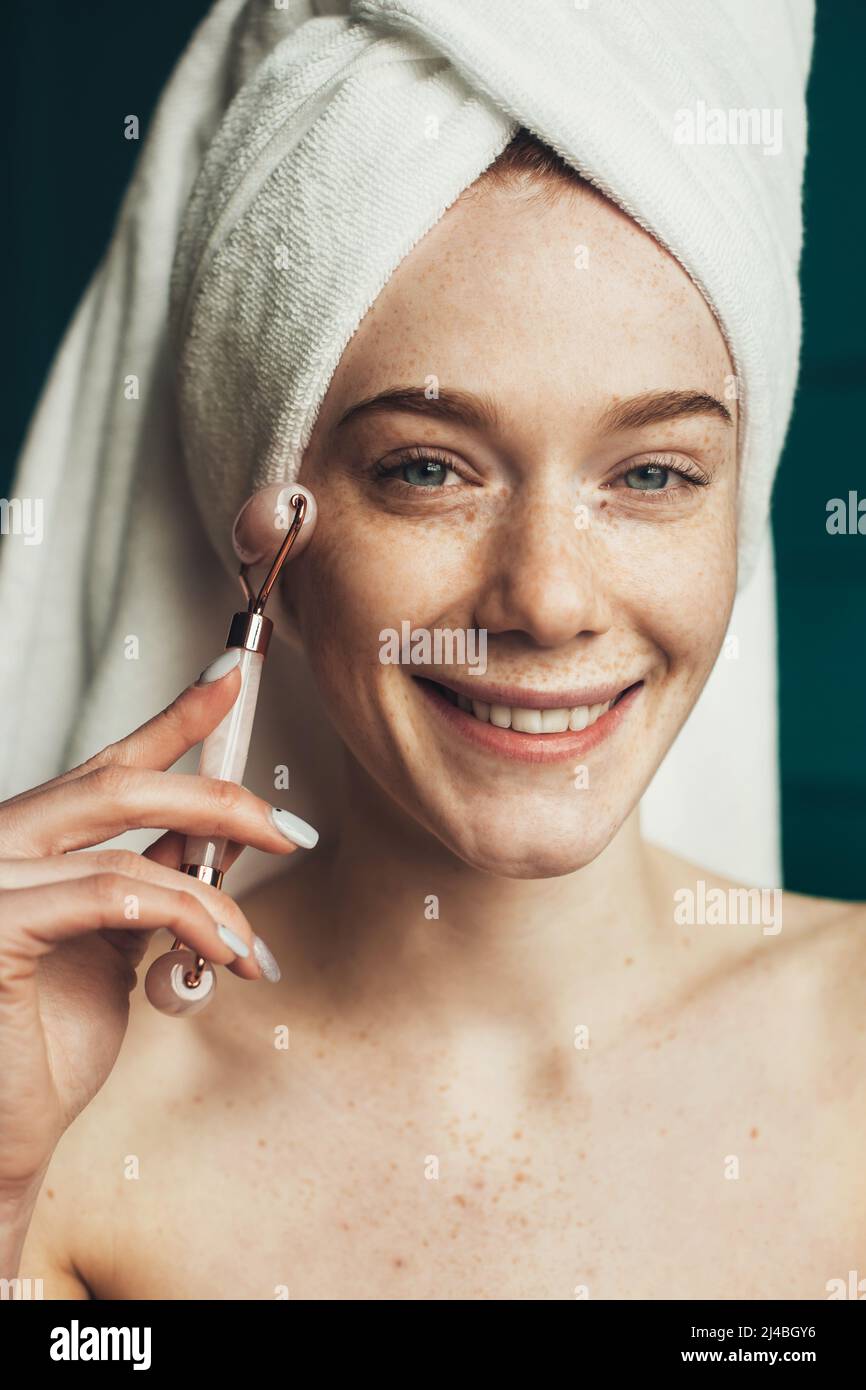 Freckled Woman Massaging Face By Jade Roller Massager After Shower Beautiful Portrait Beauty