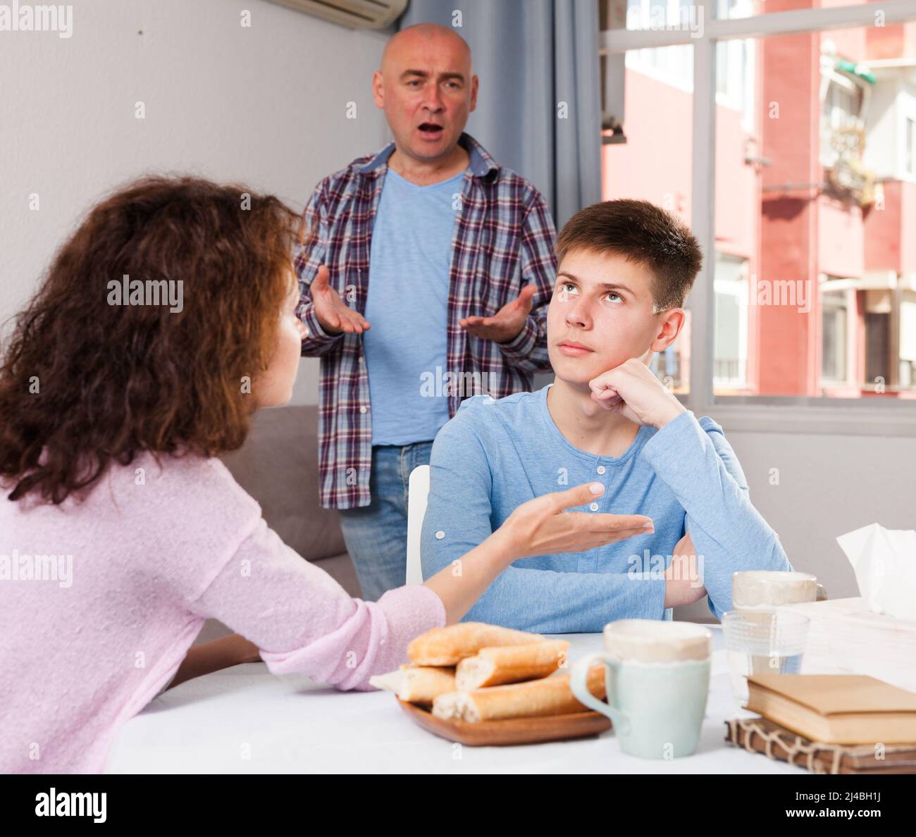 Upset teenage boy scolded by mother and father Stock Photo - Alamy