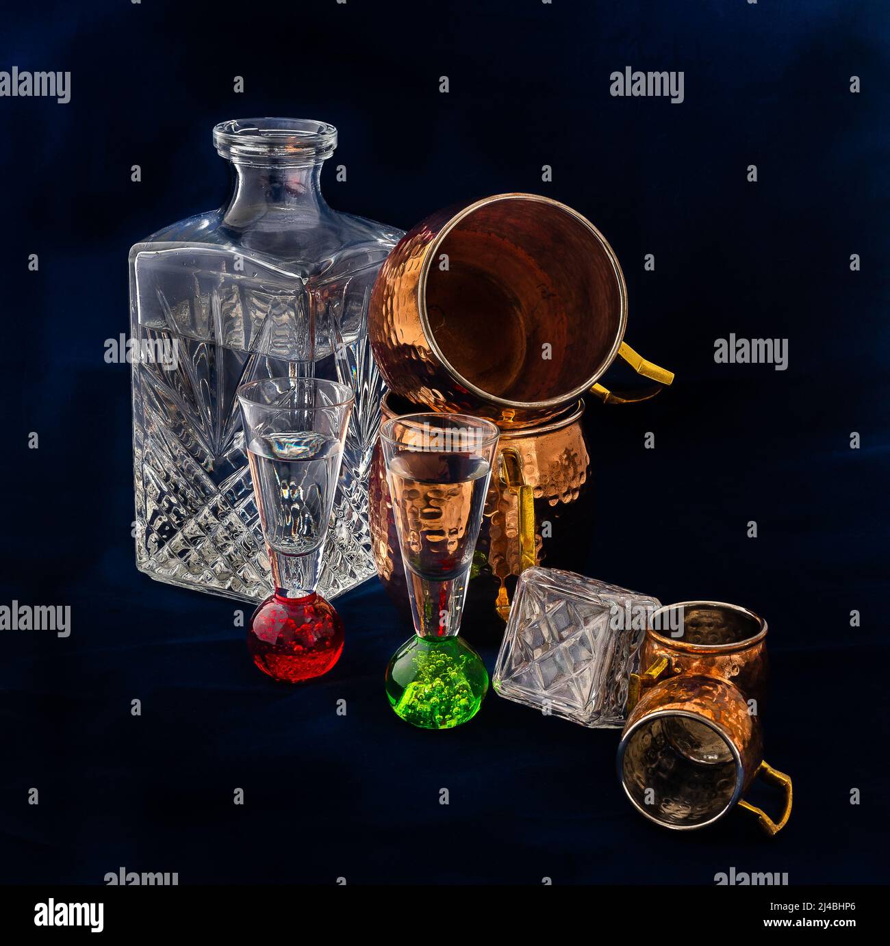 Dark and atmospheric still life photo, decanters for alcohol, glasses, mugs for drinks, made