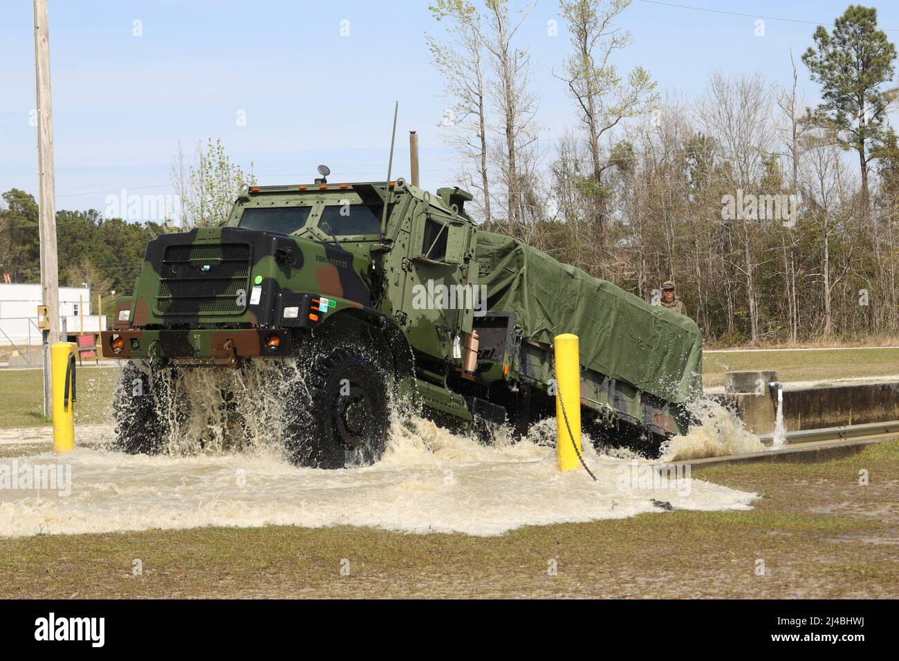 A Medium Tactical Vehicle Replacement with 3rd Landing Support Battalion, Combat Logistics Regiment 3, 3rd Marine Logistics Group, exits deep water while conducting a deep water fording training course during exercise Atlantic Dragon at Marine Corps Base Camp Lejeune, North Carolina, Mar. 29, 2022. 3rd LSB is conducting Atlantic Dragon 22 in collaboration with CLR-37, 3rd MLG, and Combat Logistics Battalion 451, CLR-45, 4th MLG, to offload, inspect, and prepare equipment for a diverse array of purposes across the Marine Corps. During the exercise, 3rd LSB is testing capabilities on conducting Stock Photo