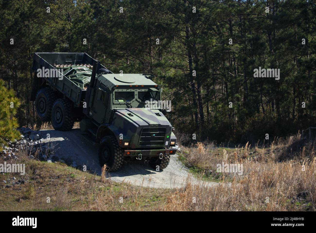 A Medium Tactical Vehicle Replacement with 3rd Landing Support Battalion, Combat Logistics Regiment 3, 3rd Marine Logistics Group, descends down a hill while conducting a Combat Vehicle Operators Training course during exercise Atlantic Dragon at Marine Corps Base Camp Lejeune, North Carolina, Mar. 28, 2022. 3rd LSB is conducting Atlantic Dragon 22 in collaboration with CLR-37, 3rd MLG, and Combat Logistics Battalion 451, CLR-45, 4th MLG, to offload, inspect, and prepare equipment for a diverse array of purposes across the Marine Corps. During the exercise, 3rd LSB is testing capabilities on c Stock Photo