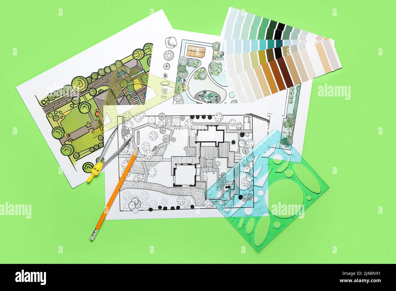 Color Landscape Plan Design Landscape designer's plans with stationery and color samples on green ...