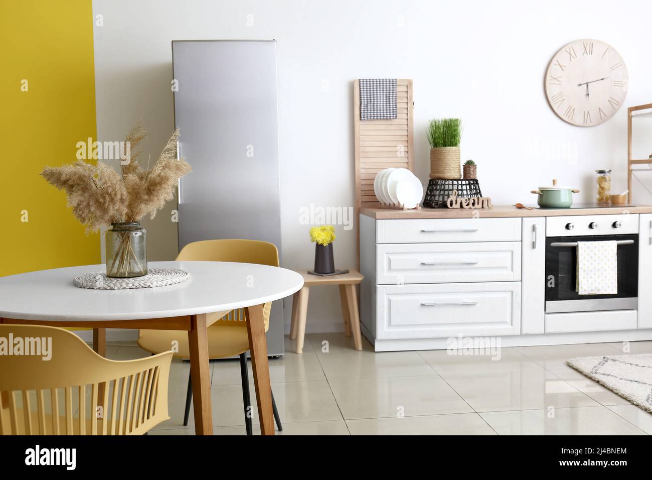 Dining table with chairs in modern interior of kitchen Stock Photo - Alamy