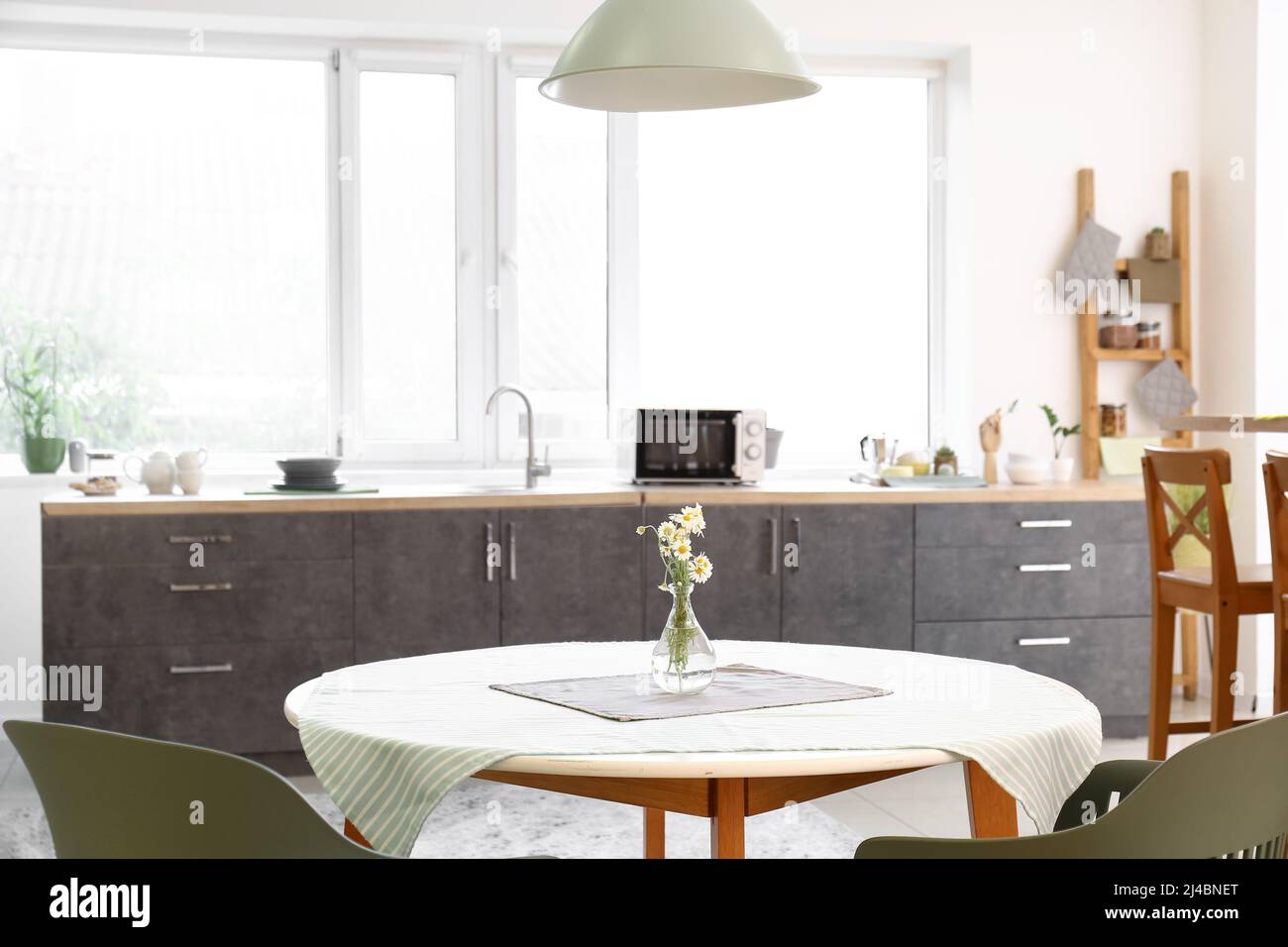 Dining table with chairs in modern interior of kitchen Stock Photo - Alamy