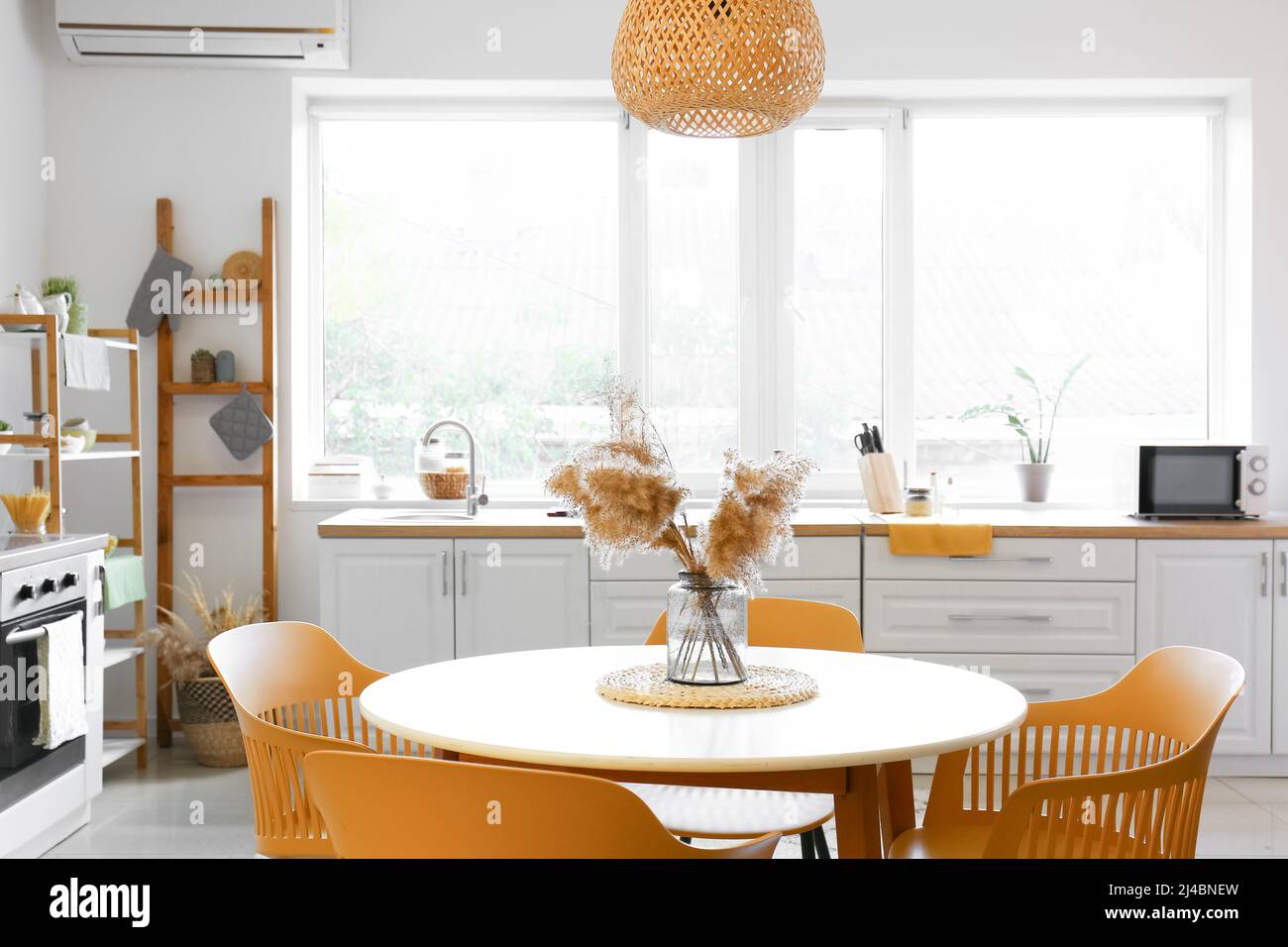 Dining table with chairs in modern interior of kitchen Stock Photo - Alamy