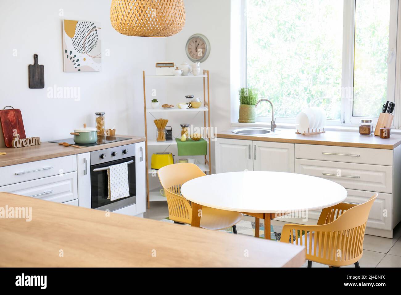 Dining table with chairs in modern interior of kitchen Stock Photo - Alamy
